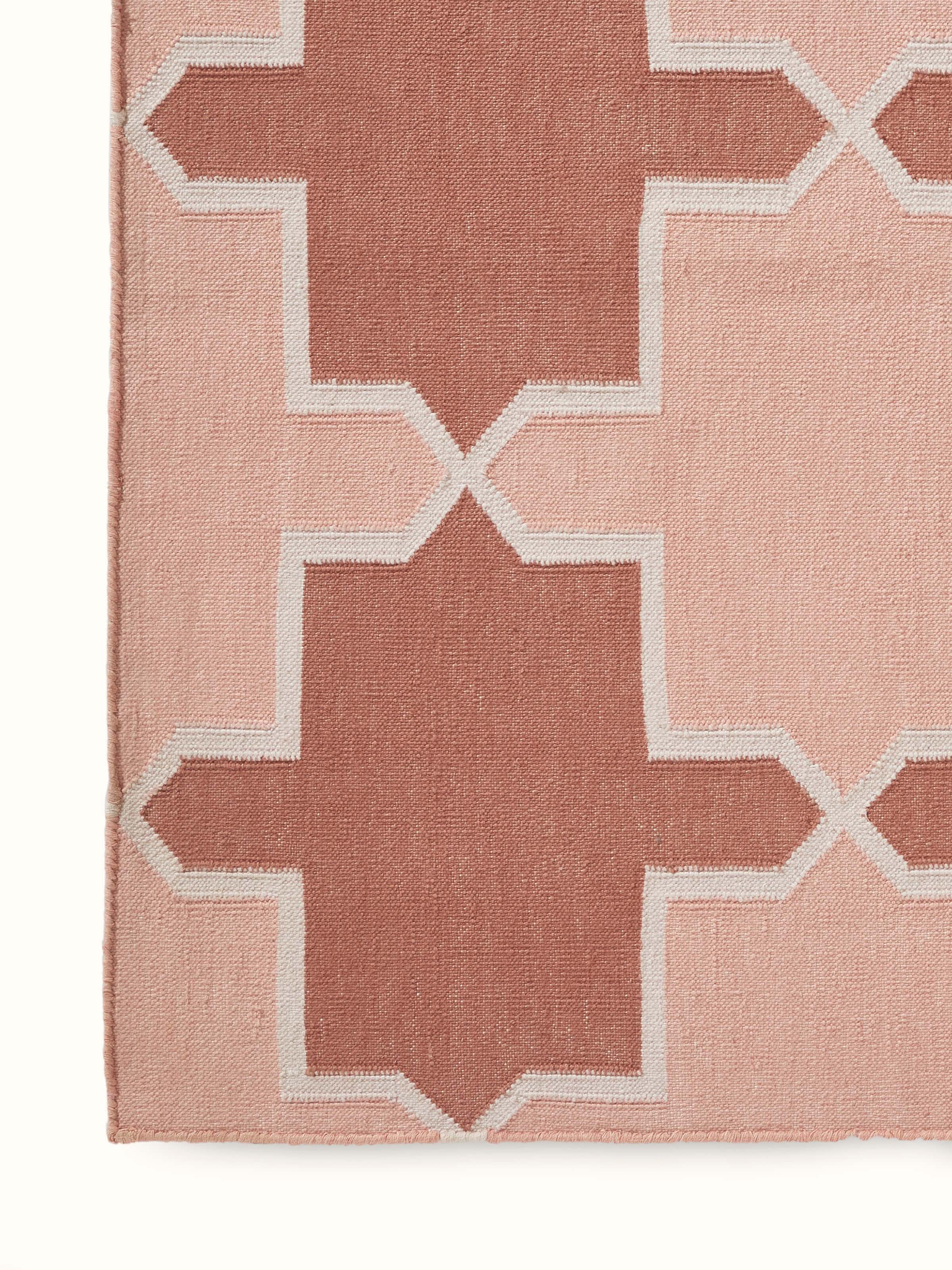 Detailed view of Modern Geo Red Blush Lawan Cotton Panja Dhurrie highlighting the weaving and color patterns