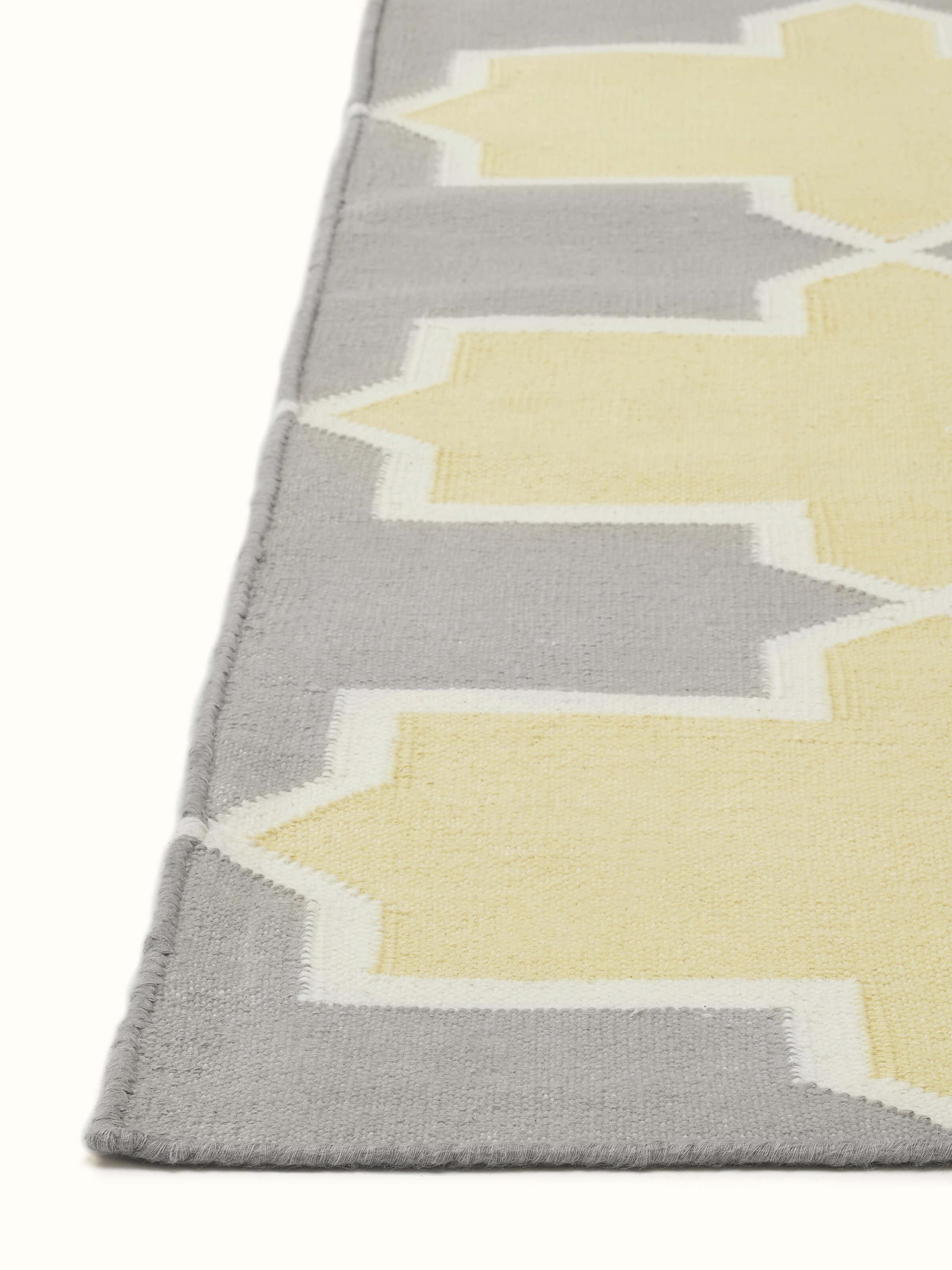 Detailed view of Modern Geo grey yellow Lawan cotton panja dhurrie focusing on the texture and color contrast