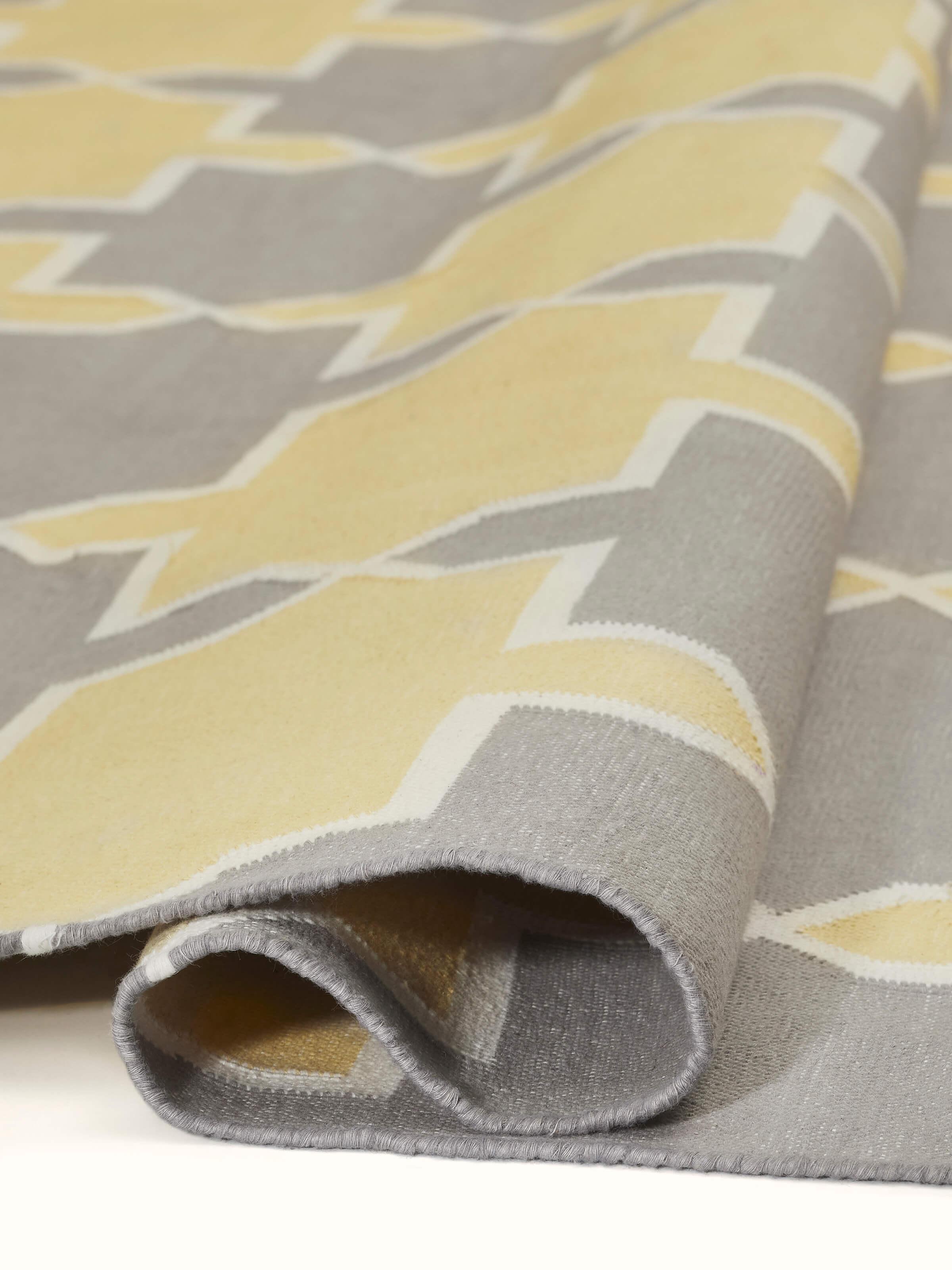 Top view of Modern Geo grey yellow Lawan cotton panja dhurrie displaying the full pattern and color layout
