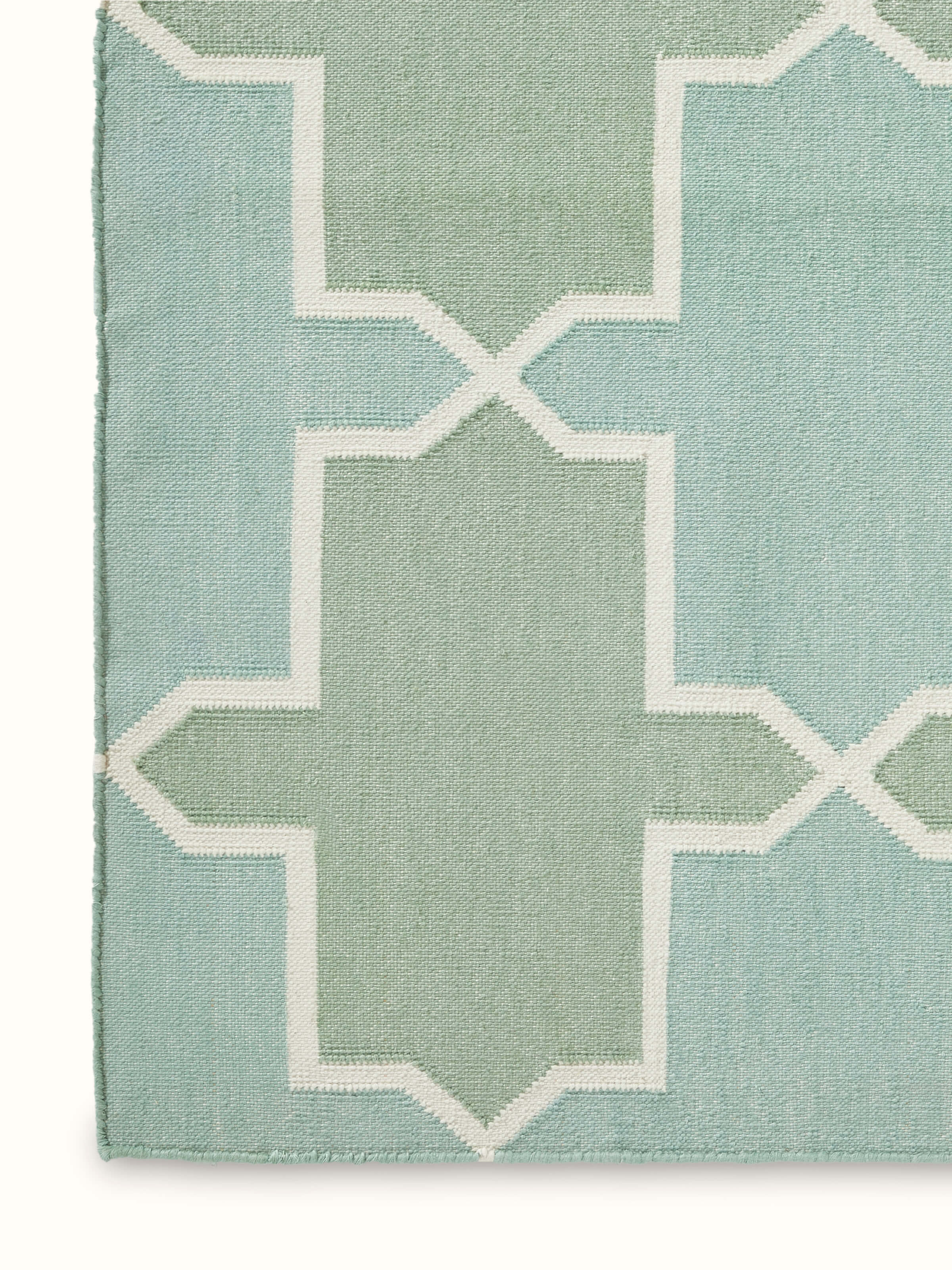 Side view of Modern Geo Green Lawan Cotton Panja Dhurrie illustrating the vibrant geometric design