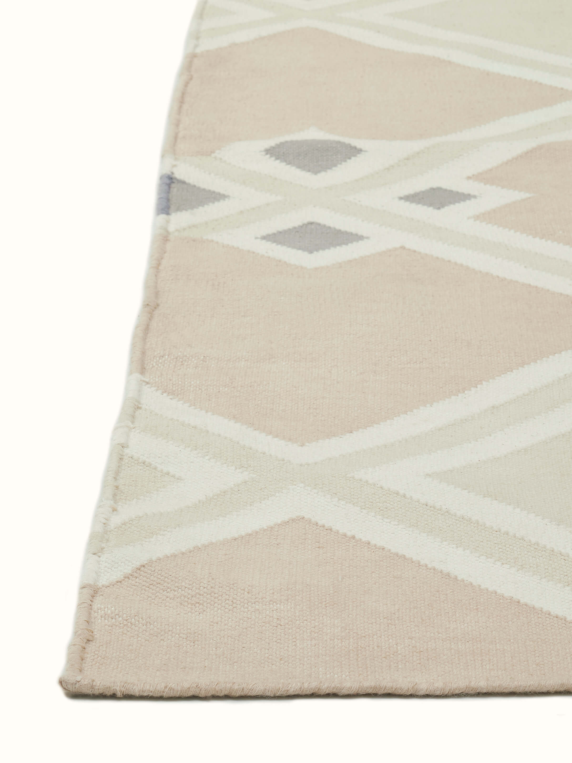 Full view of Modern Geo Diamond beige-grey Lawan cotton panja dhurrie, demonstrating the stylish diamond motif and its application in a room setting