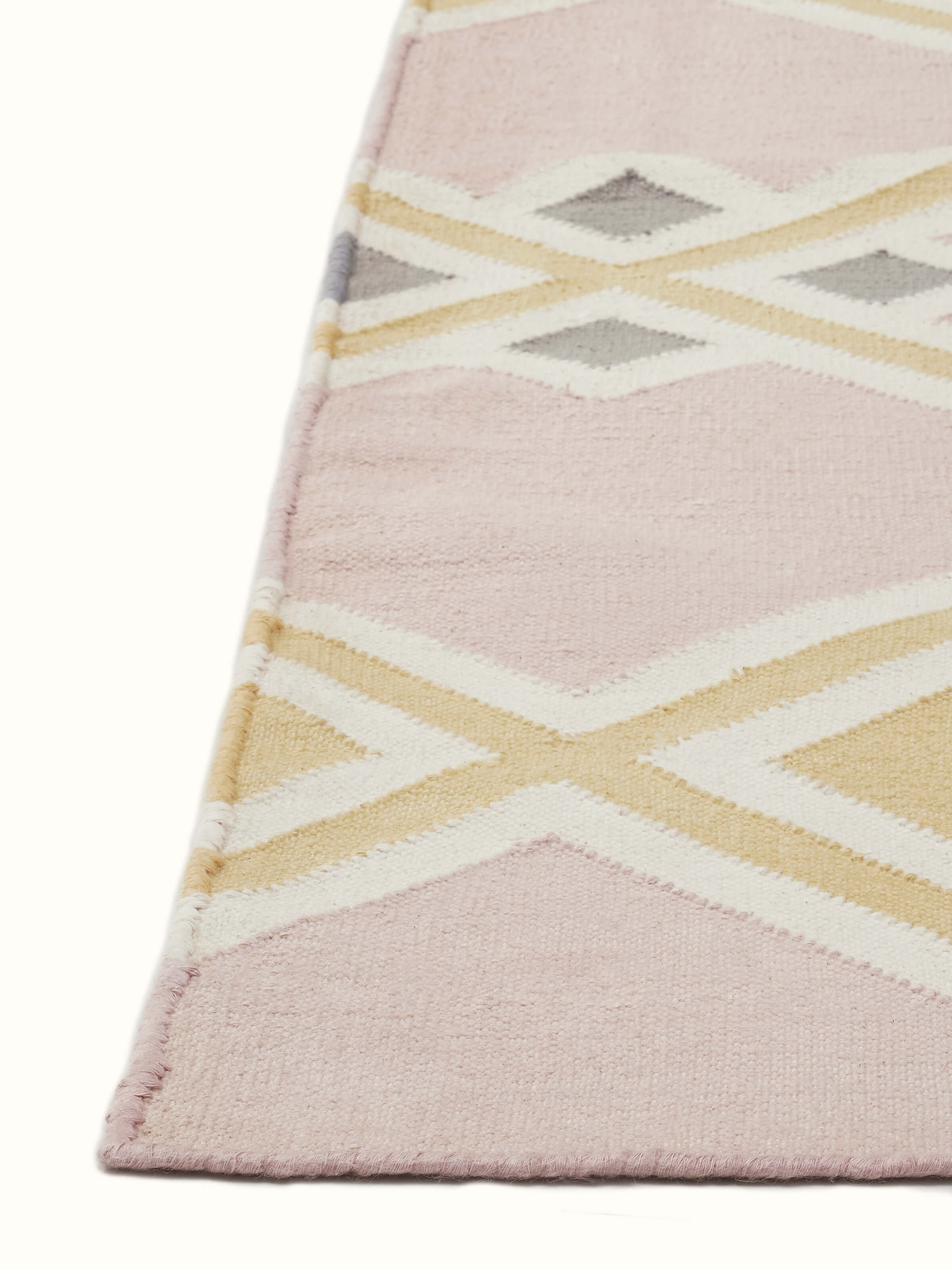 Detailed view of Modern geo light pink lawan cotton panja dhurrie highlighting the elegant pattern and color.