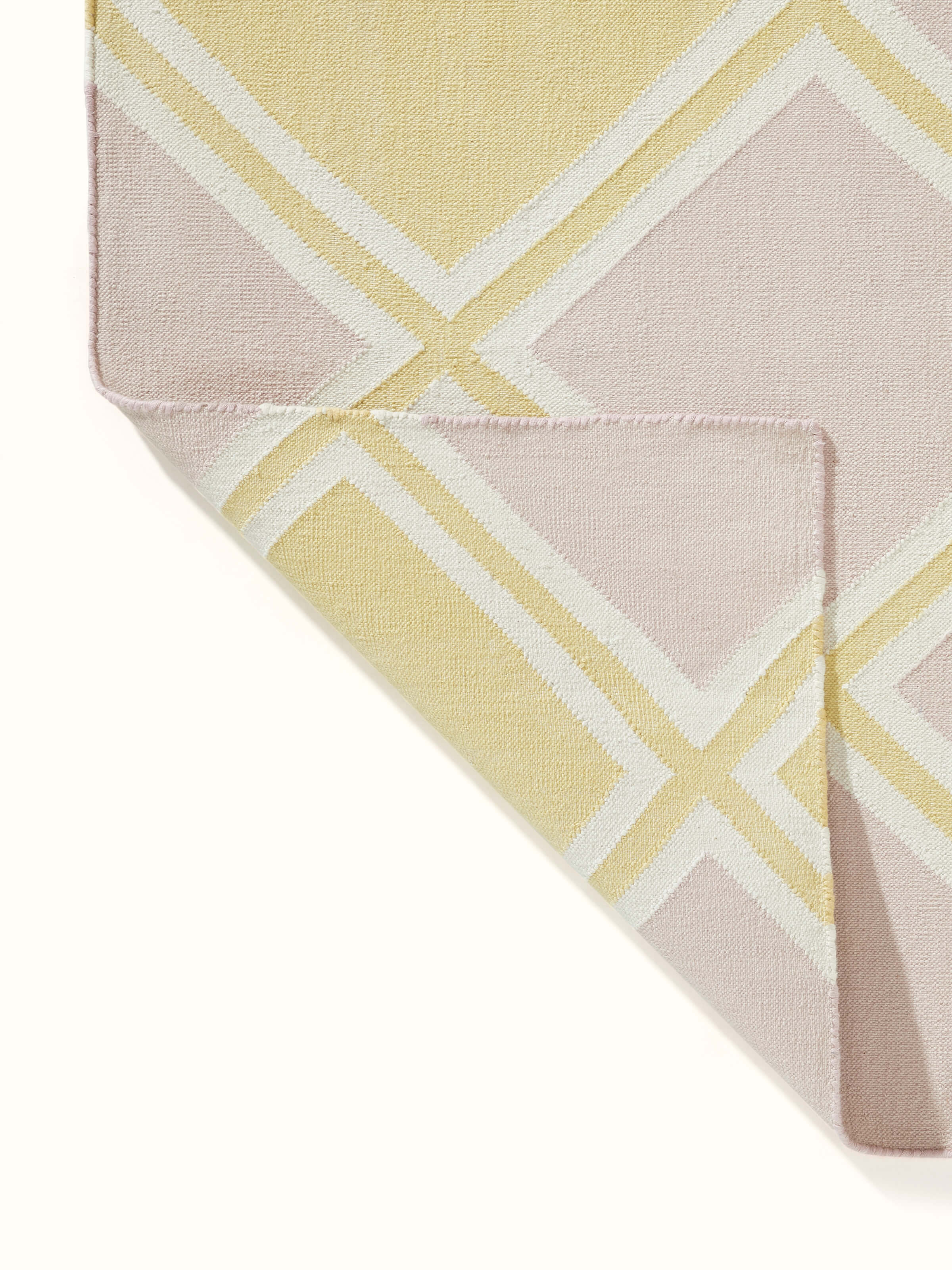 Modern geo light pink lawan cotton panja dhurrie featuring a full view of its stylish geometric pattern and soft texture.