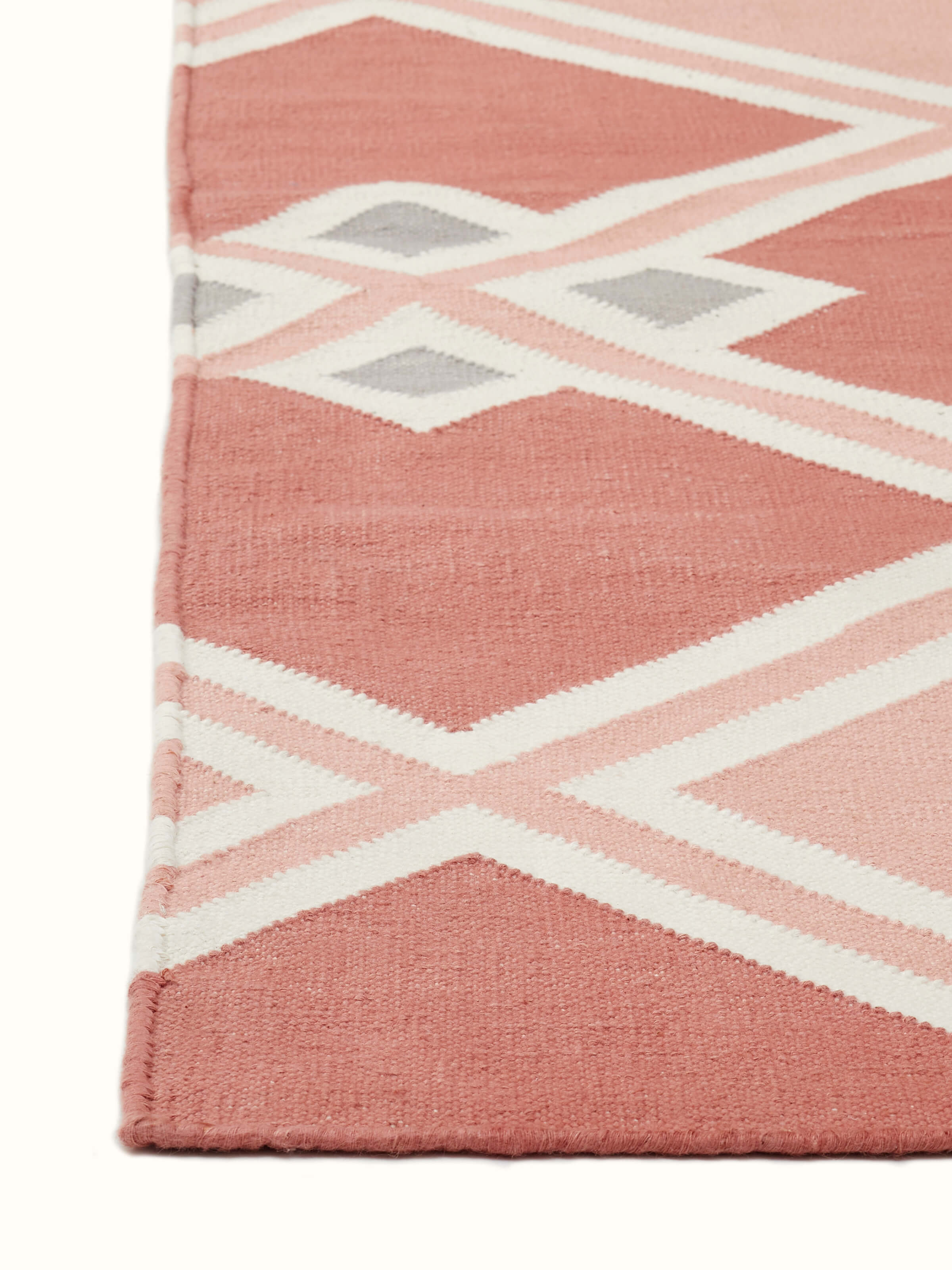 Detailed view of Modern geo diamond red blush lawan cotton panja dhurrie emphasizing the intricate geometric pattern.