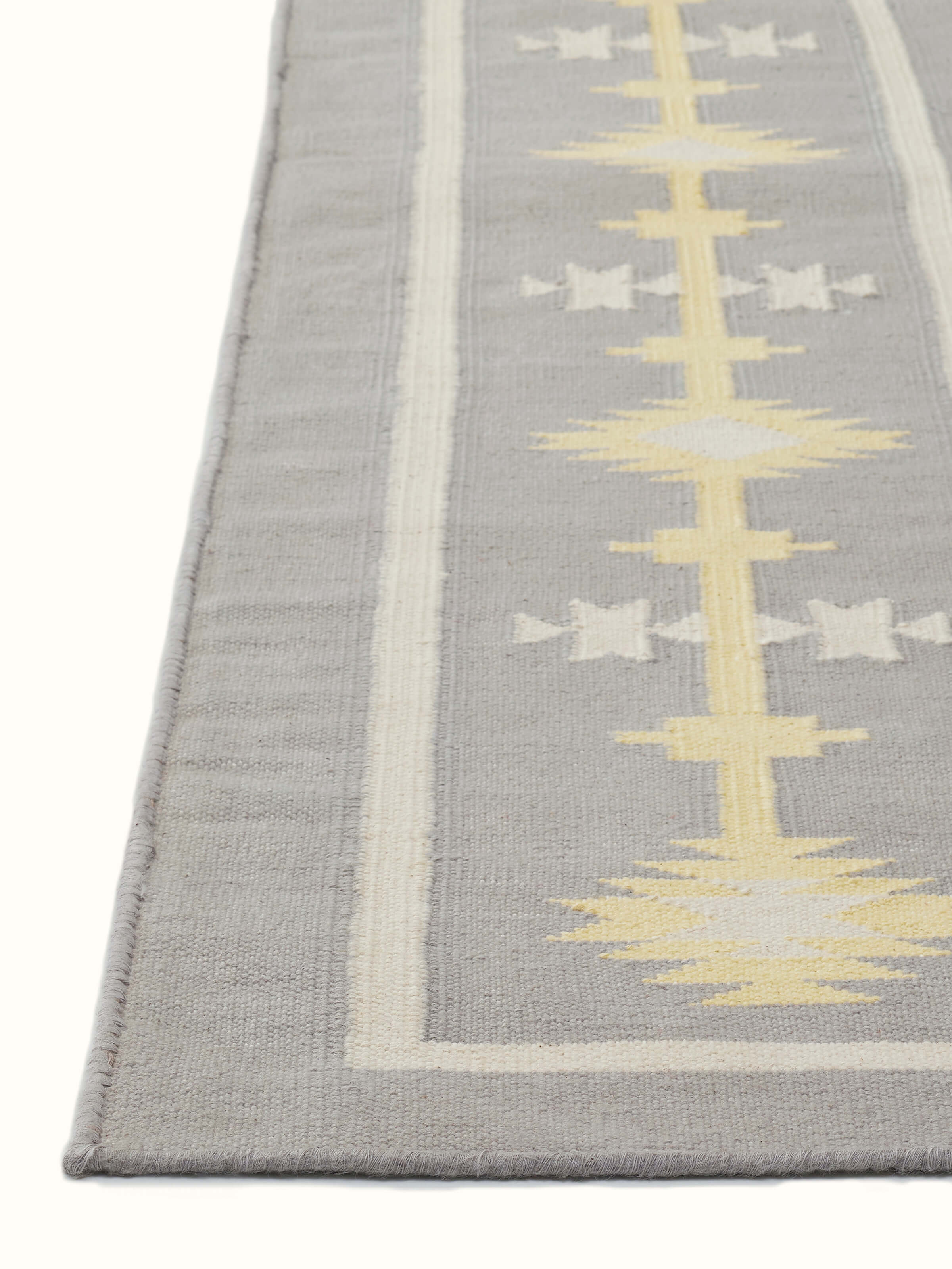 Traditional Kilim grey yellow Lawan cotton Panja dhurrie in use, showcasing its design in a setting