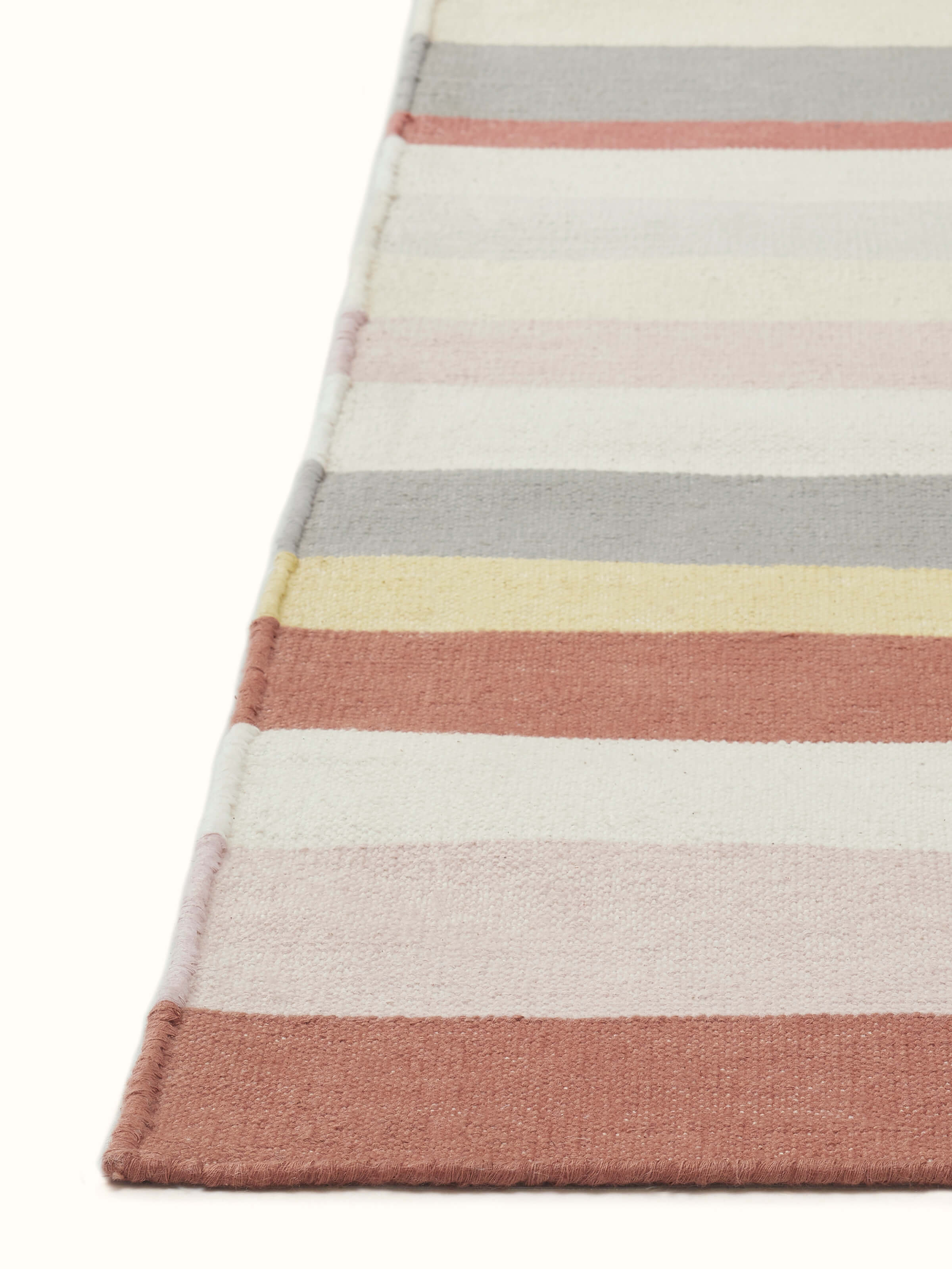 Detailed view of Modern geo stripe rust lawan cotton panja dhurrie focusing on the geo stripe pattern and fabric quality.