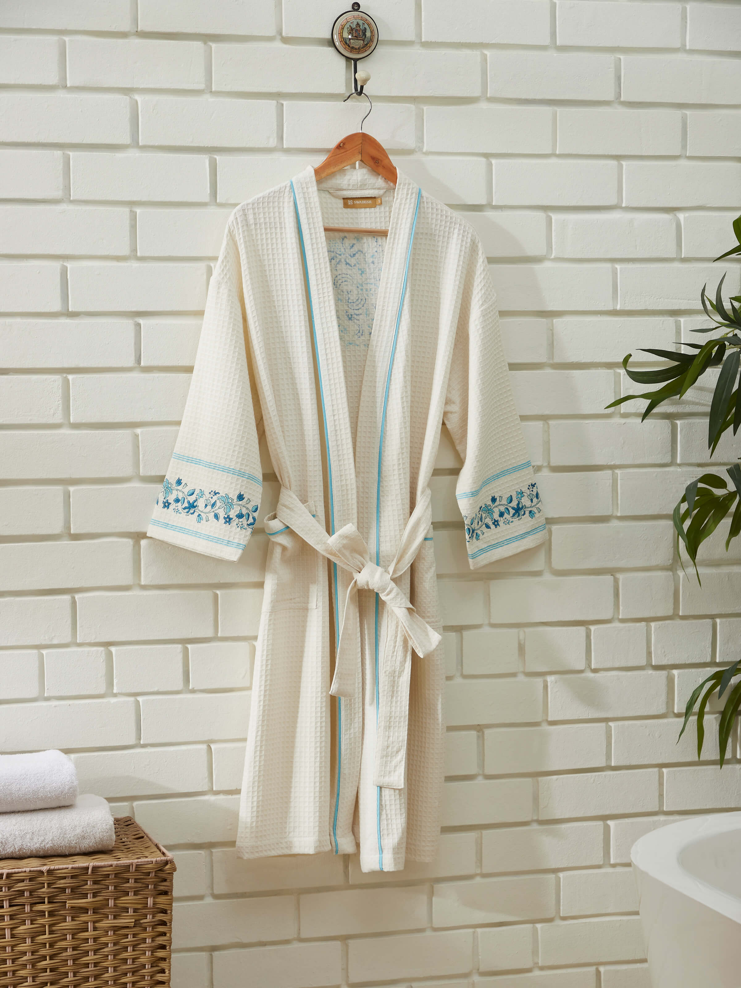 Detailed view of Blue floral cotton Sanganeri block printed bathrobe showcasing the vibrant floral design and fabric texture.