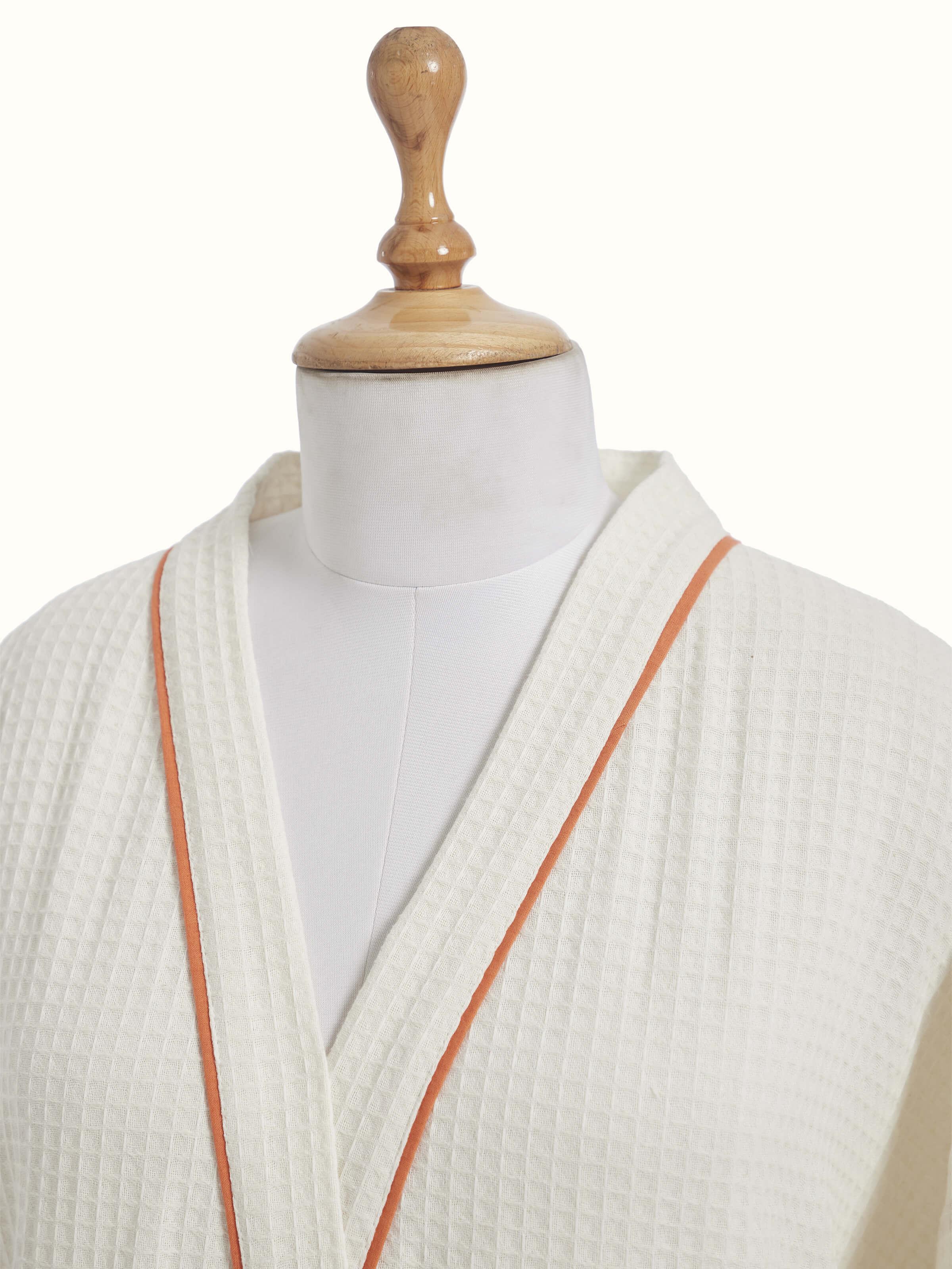 Close-up of Palampore buta peach floral cotton Sanganeri block printed bathrobe highlighting fabric texture and print