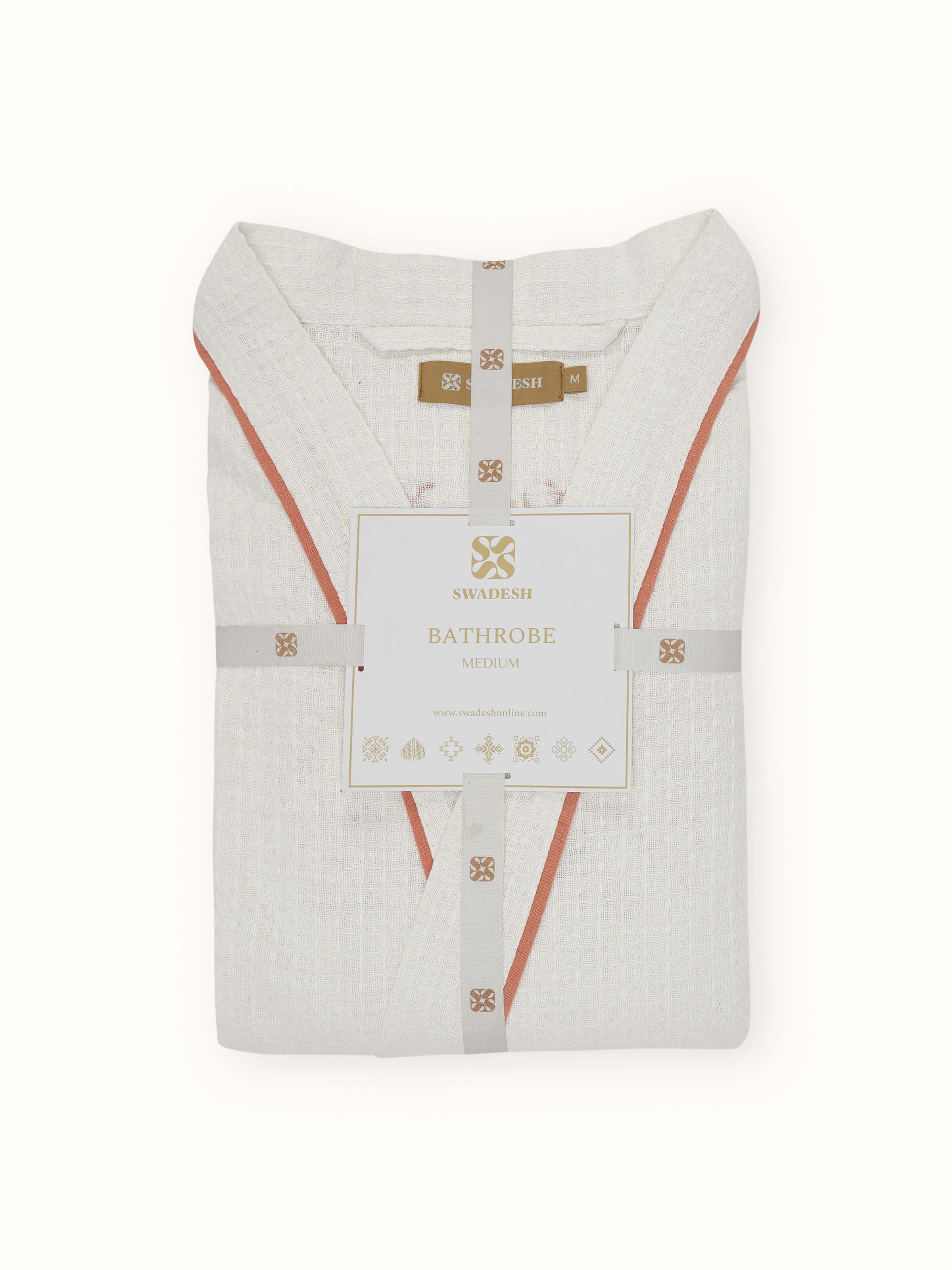 Angled view of Palampore buta peach floral cotton Sanganeri block printed bathrobe displaying overall design