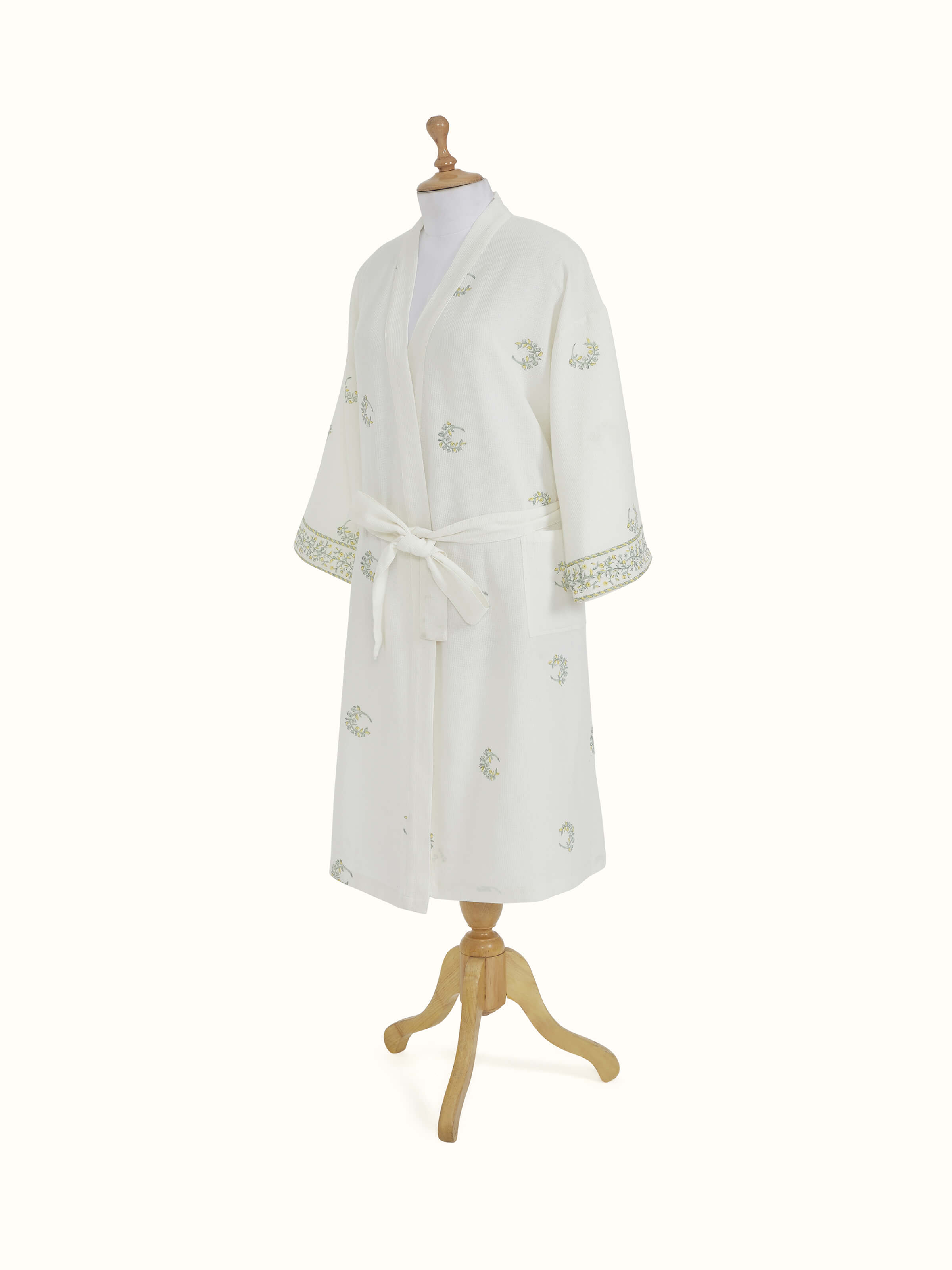 Close-up of the floral print on Ambi Buta yellow cotton Sanganeri block printed bathrobe