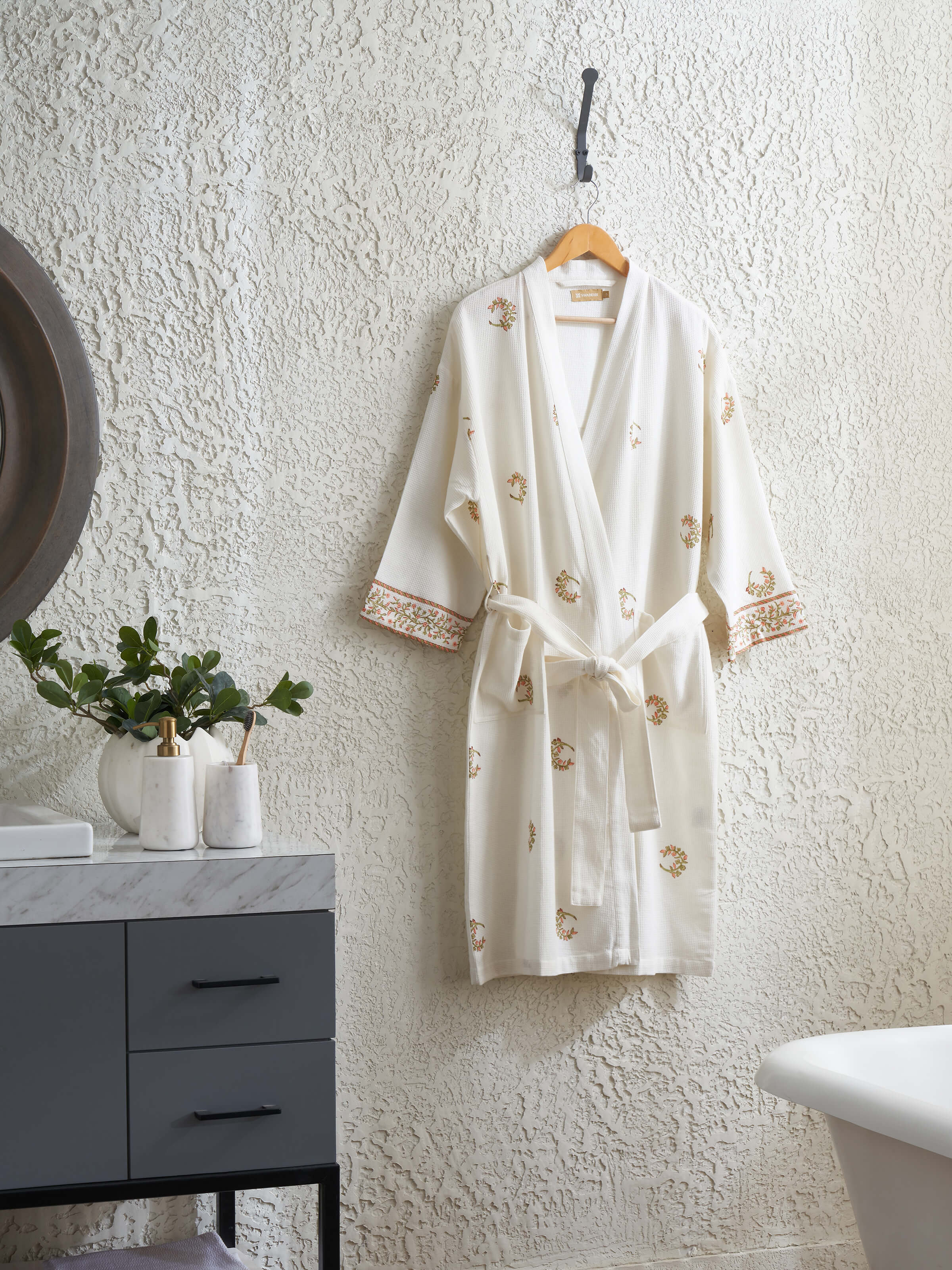 Close-up view of Ambi Buta peach floral cotton Sanganeri block printed bathrobe, showing the fabric detail