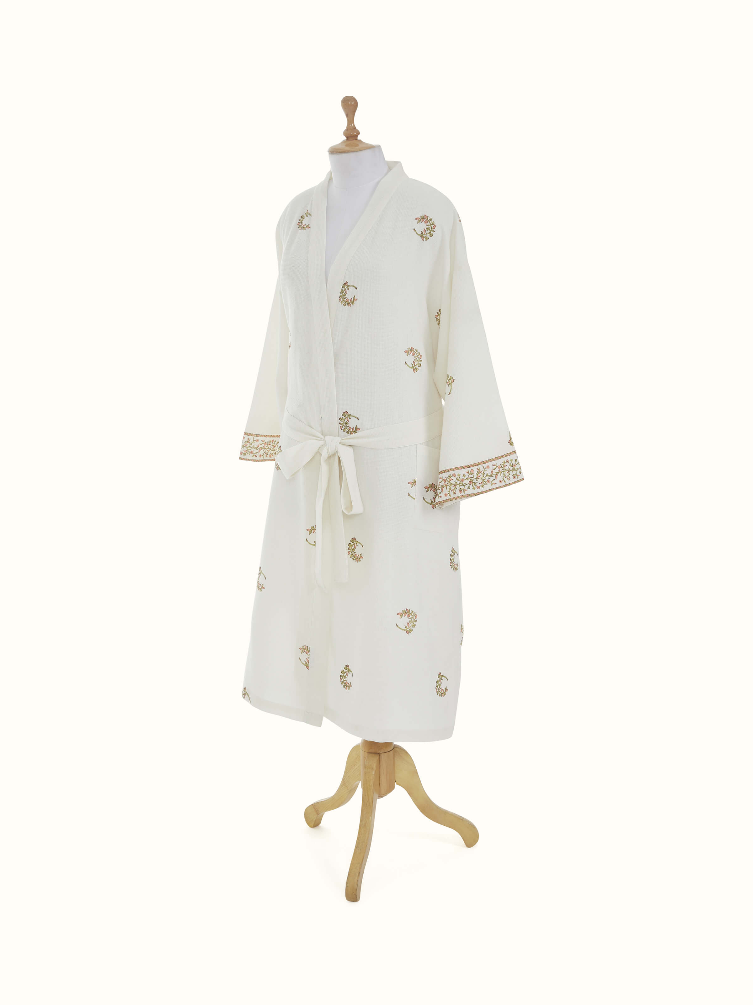 Detailed view of floral pattern on Ambi Buta peach cotton Sanganeri block printed bathrobe