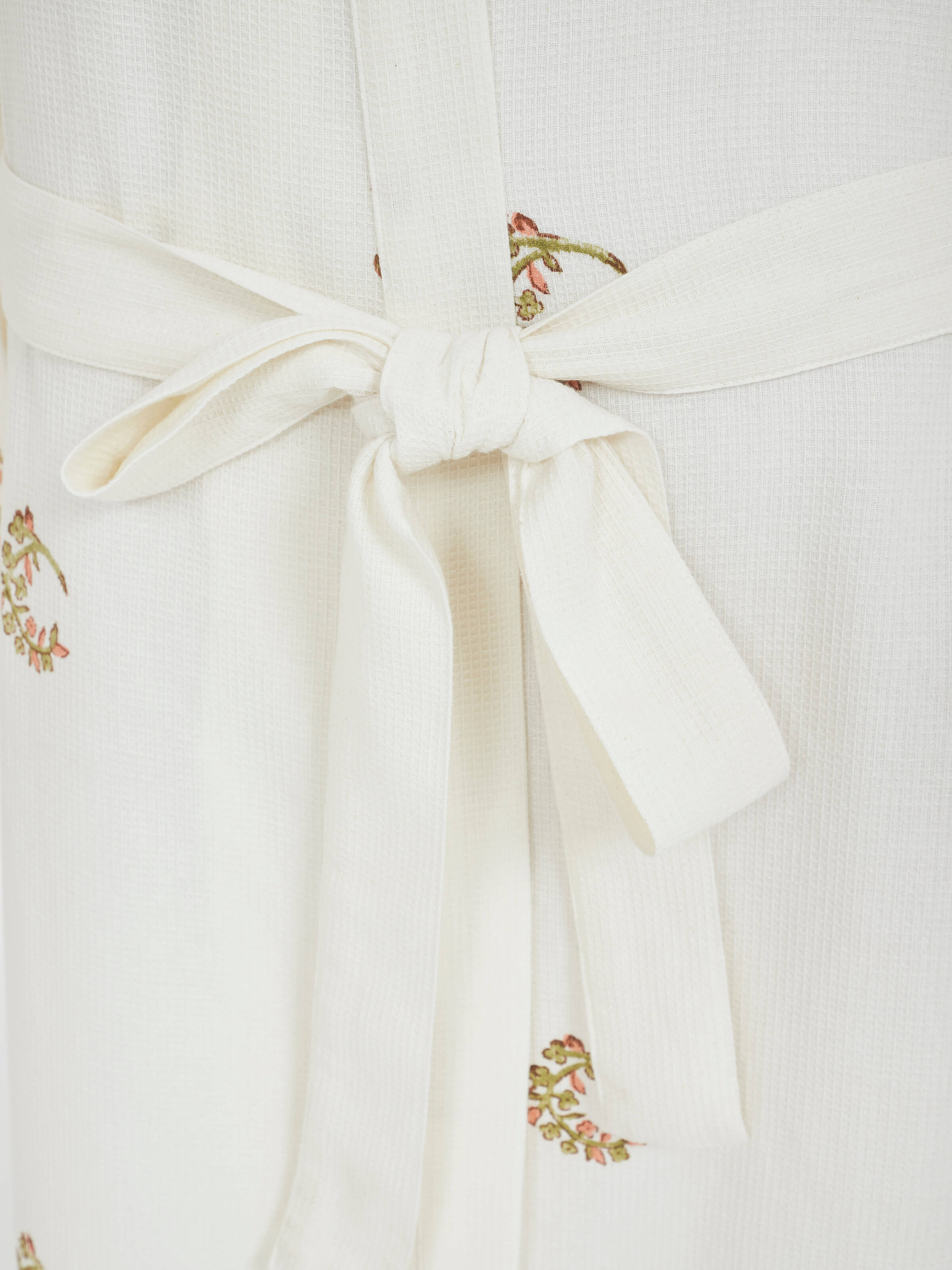 Close-up of the block printed design on Ambi Buta peach cotton Sanganeri bathrobe
