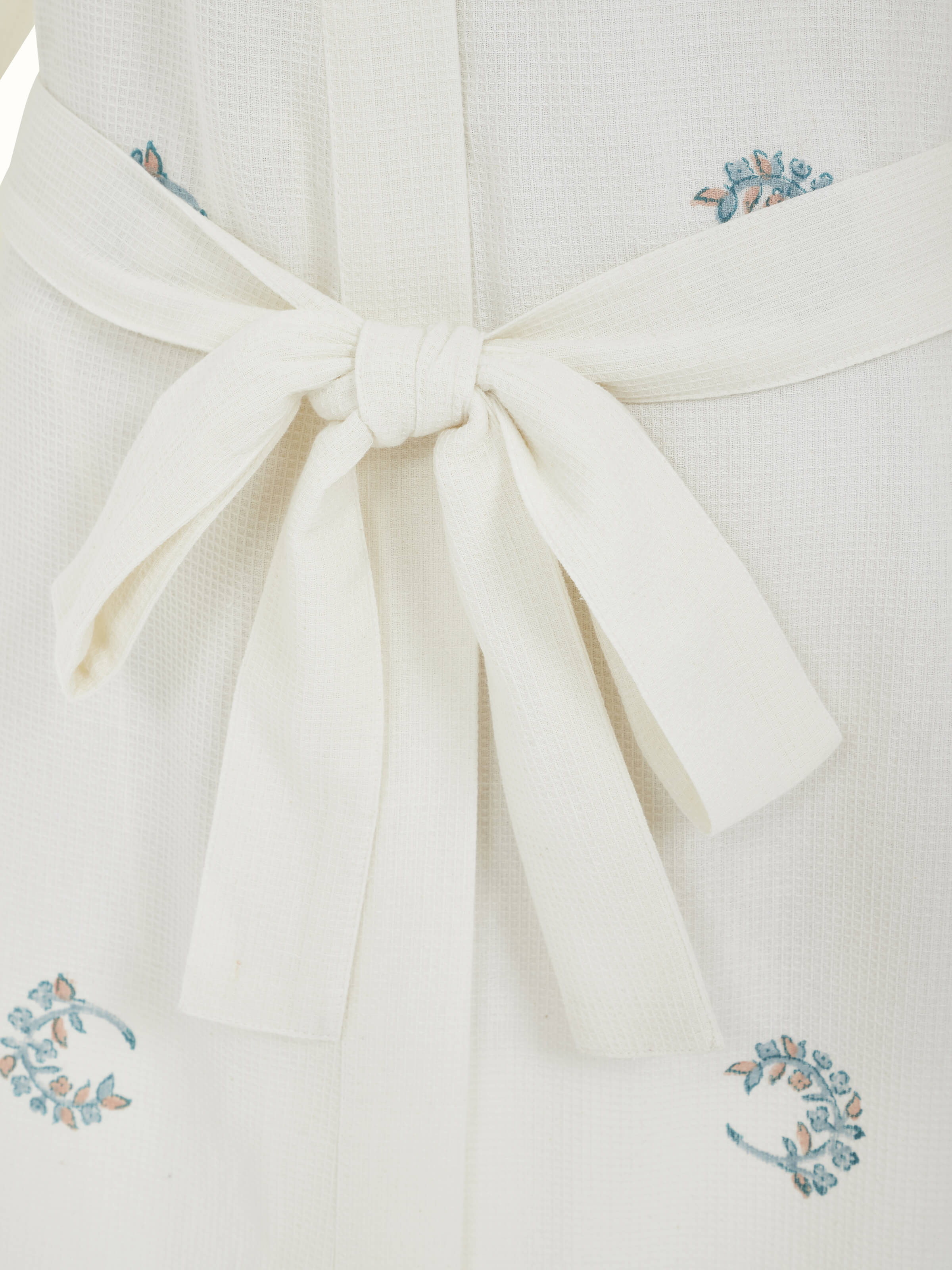 Detailed close-up of the blue floral Sanganeri bathrobe showing the texture and craftsmanship of the block print