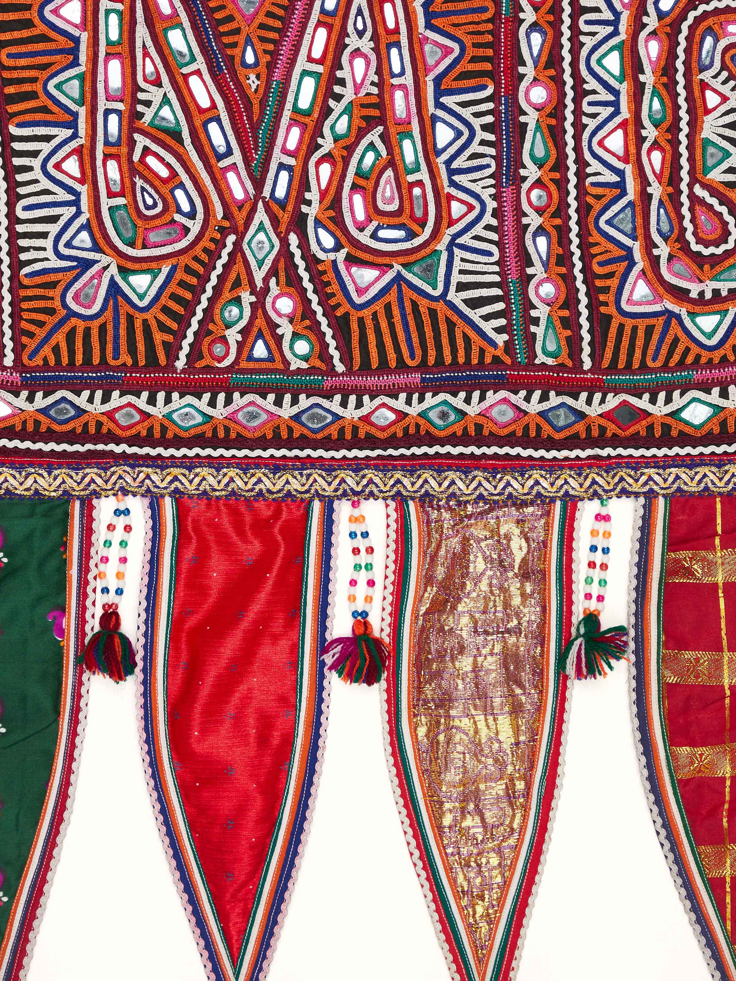 Detailed view of Kutch embroidery toran showing the fine stitchwork and vibrant colors