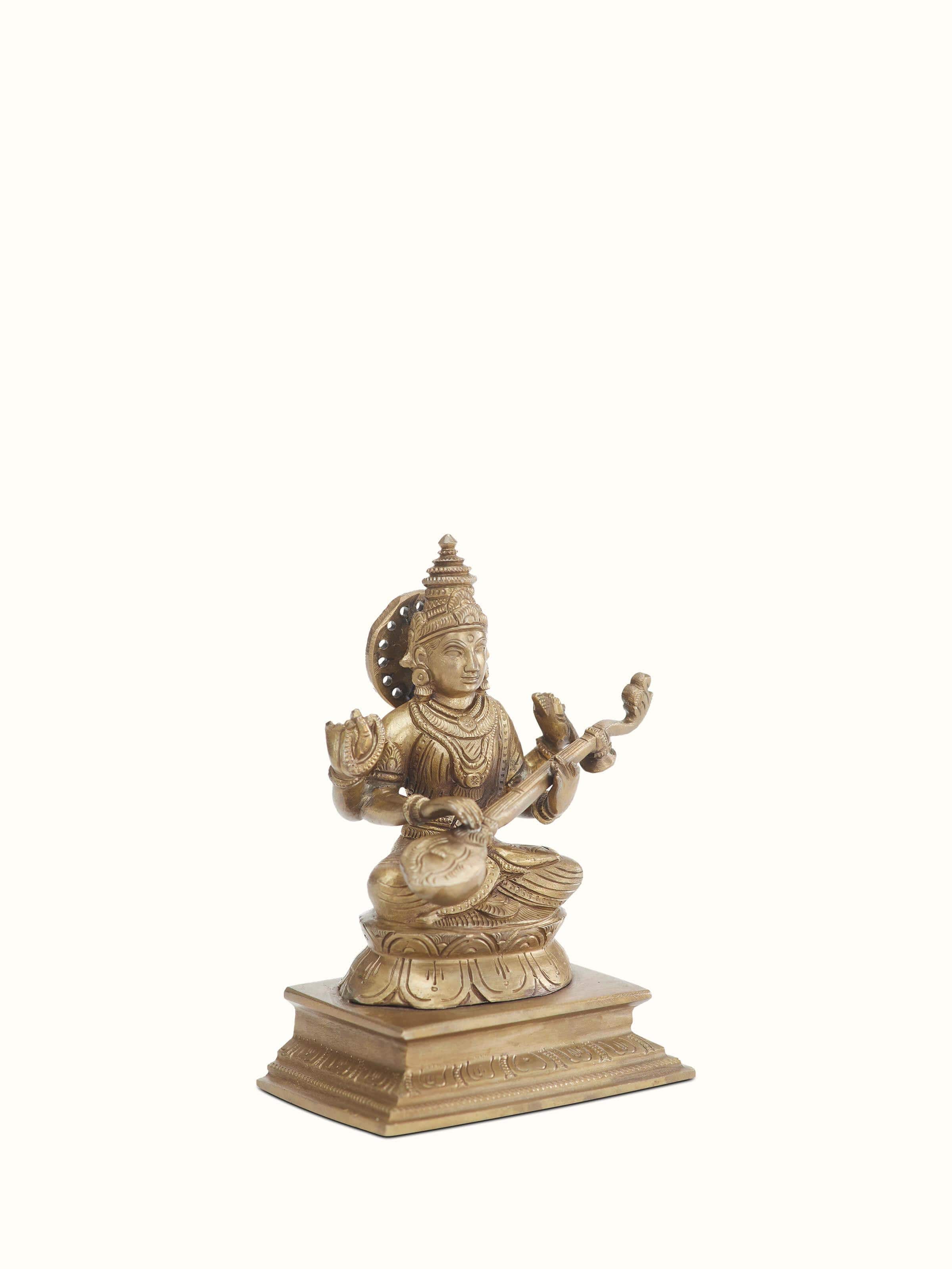 Angled view of Saraswathi bronze casting idol emphasizing the intricate details and bronze finish