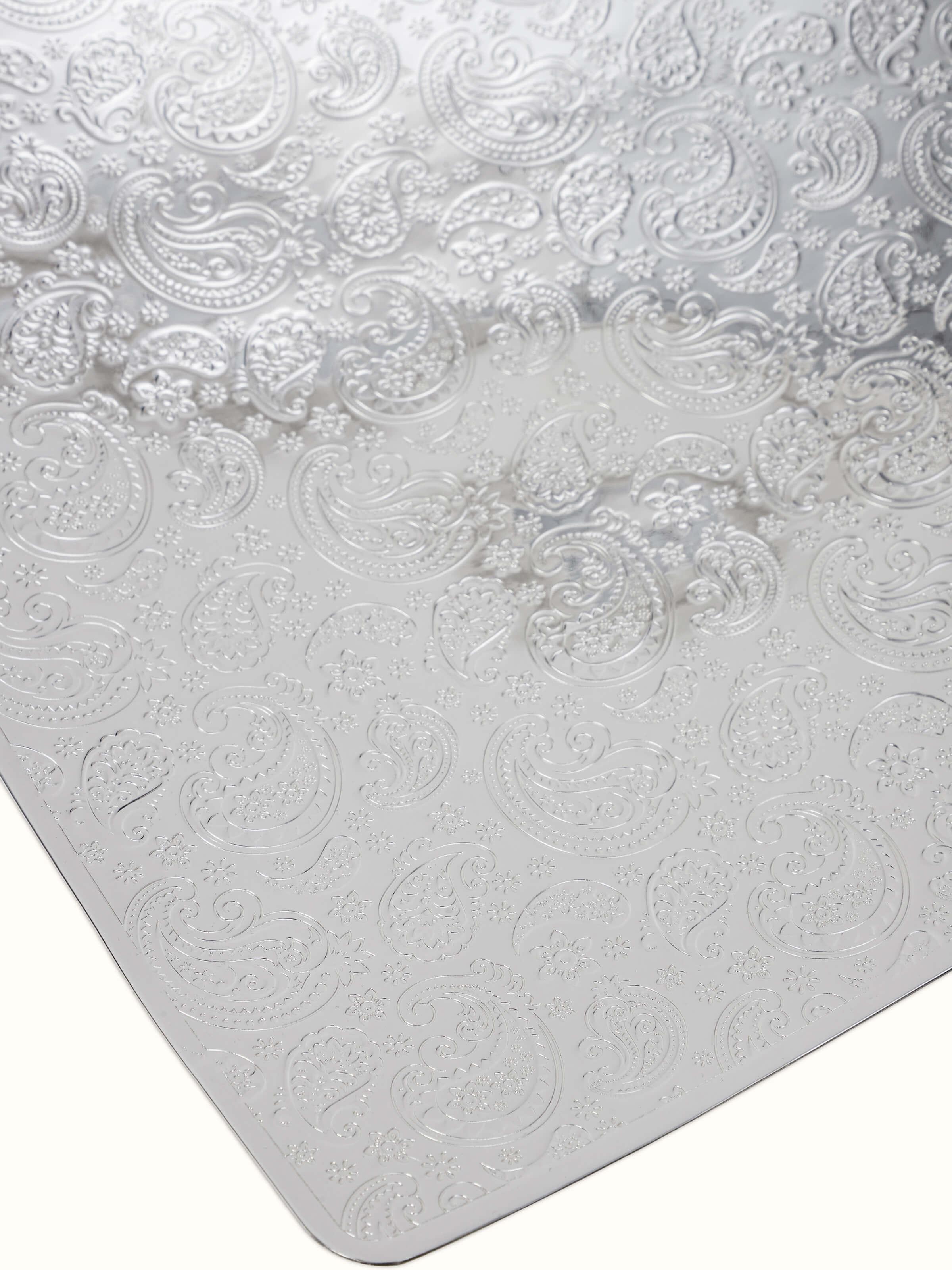 Close-up of silver-plated paisley square platter showing ornate paisley design.