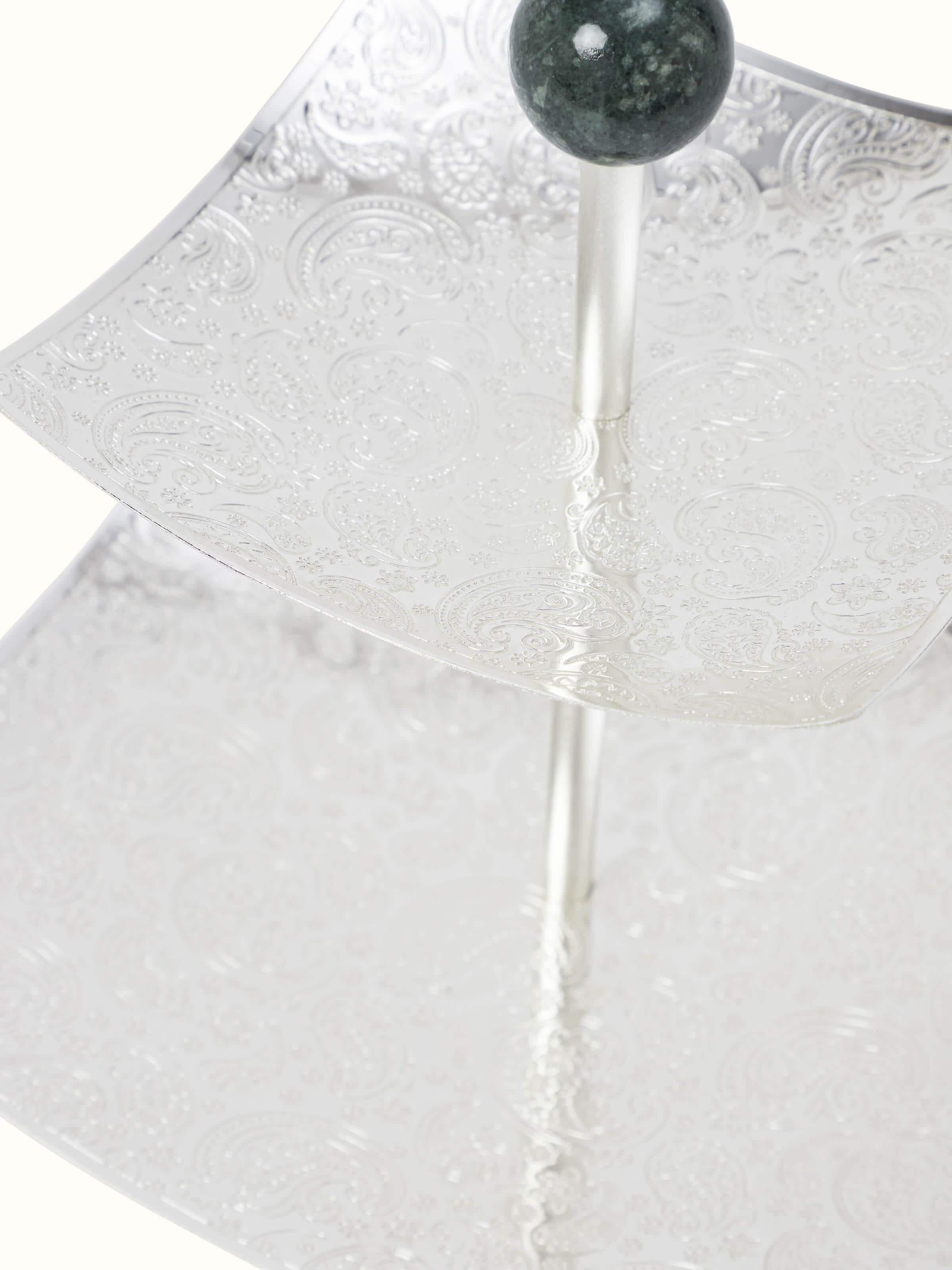 Close-up view of silver-plated paisley 2-tier square platter with detailed paisley design and finish