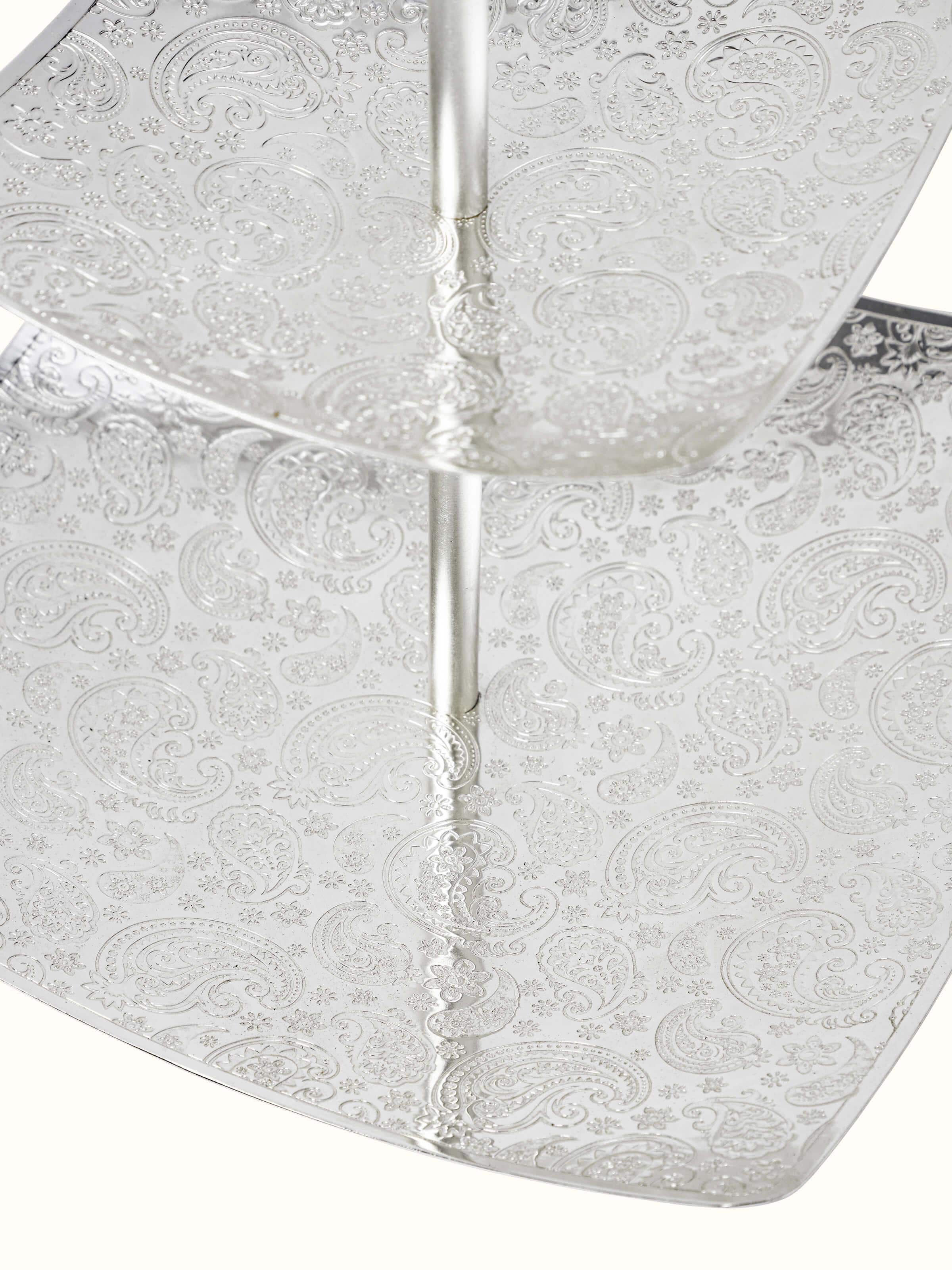 Side view of silver-plated paisley 2-tier square platter highlighting the tiered design and ornate patterns
