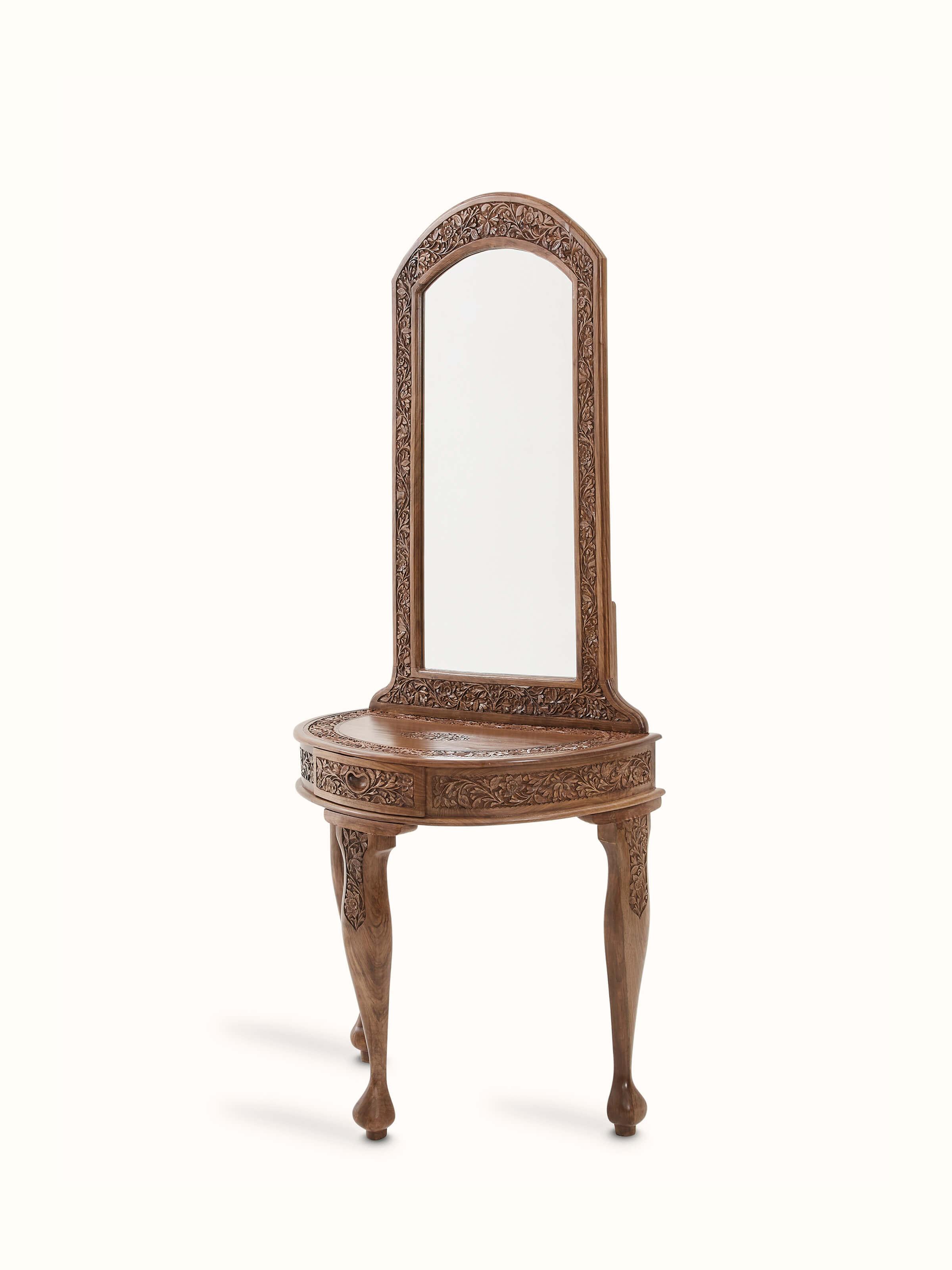 Angled view of the carved walnut wood and glass dressing table, showing the ornate details and elegant design