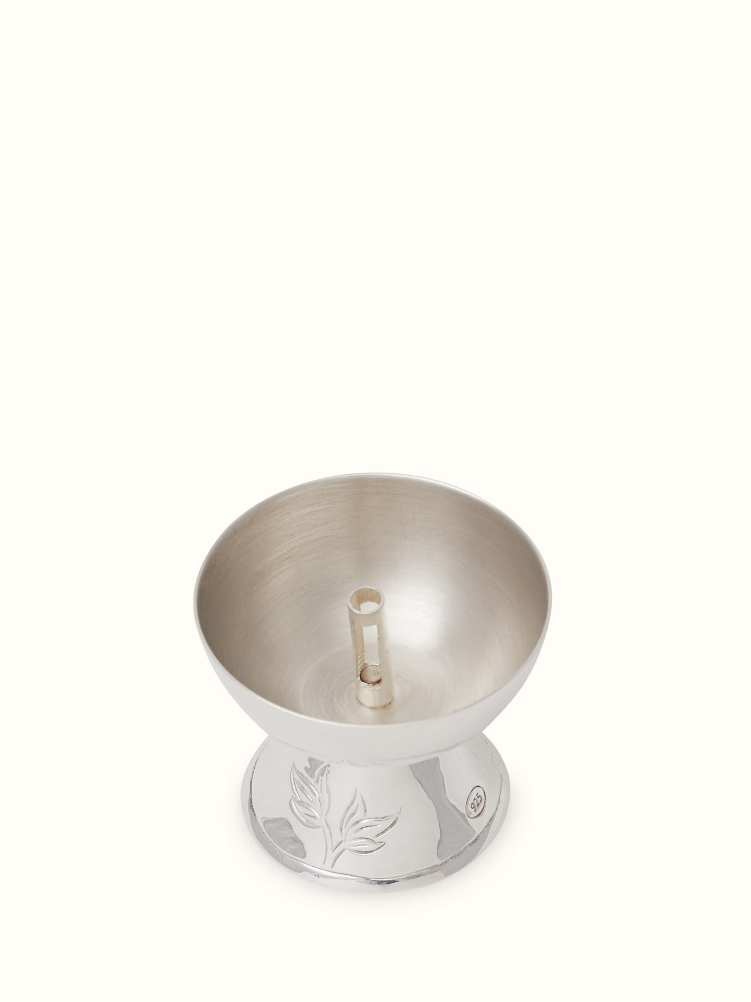 Close-up of Silver basant diya highlighting its intricate details
