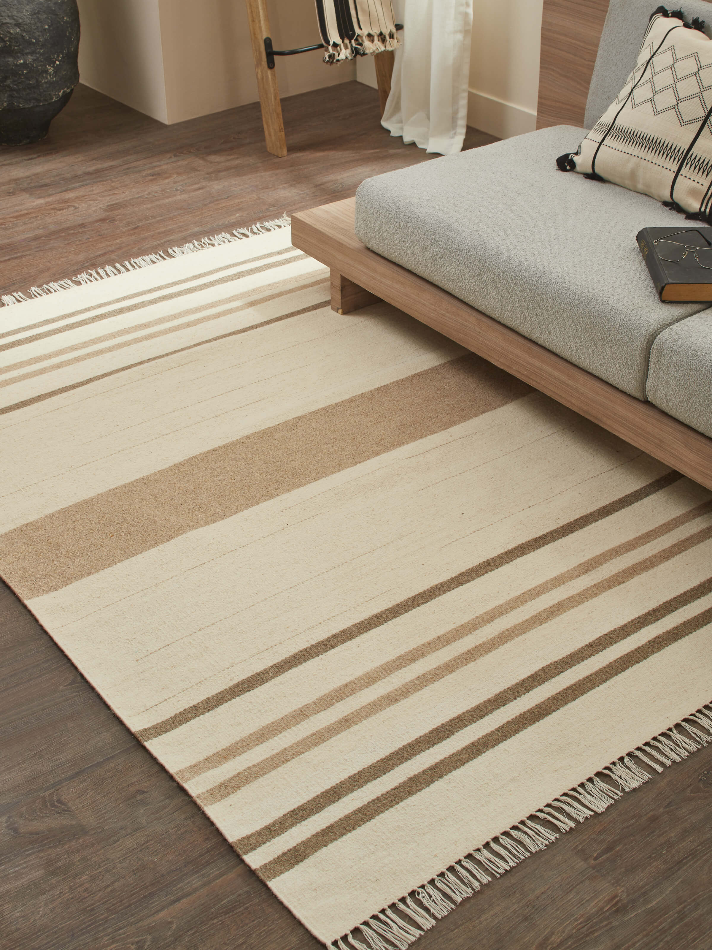 Lifestyle image of Nomad Stripes ivory wool dhurrie showcasing traditional Jawaja handloom craft