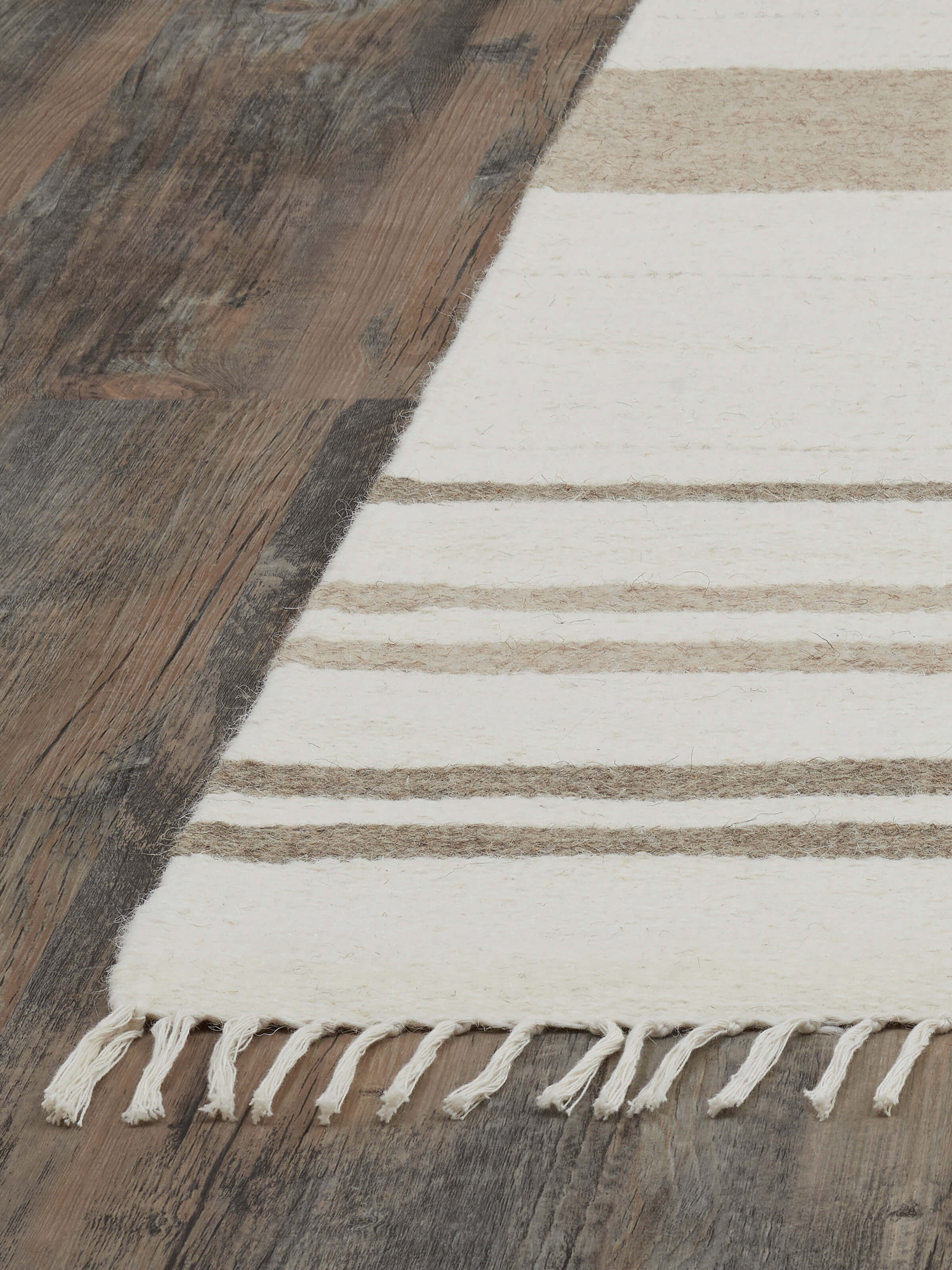 Nomad stripes ivory Jawaja wool & cotton handloom dhurrie in a room setting, emphasizing its design