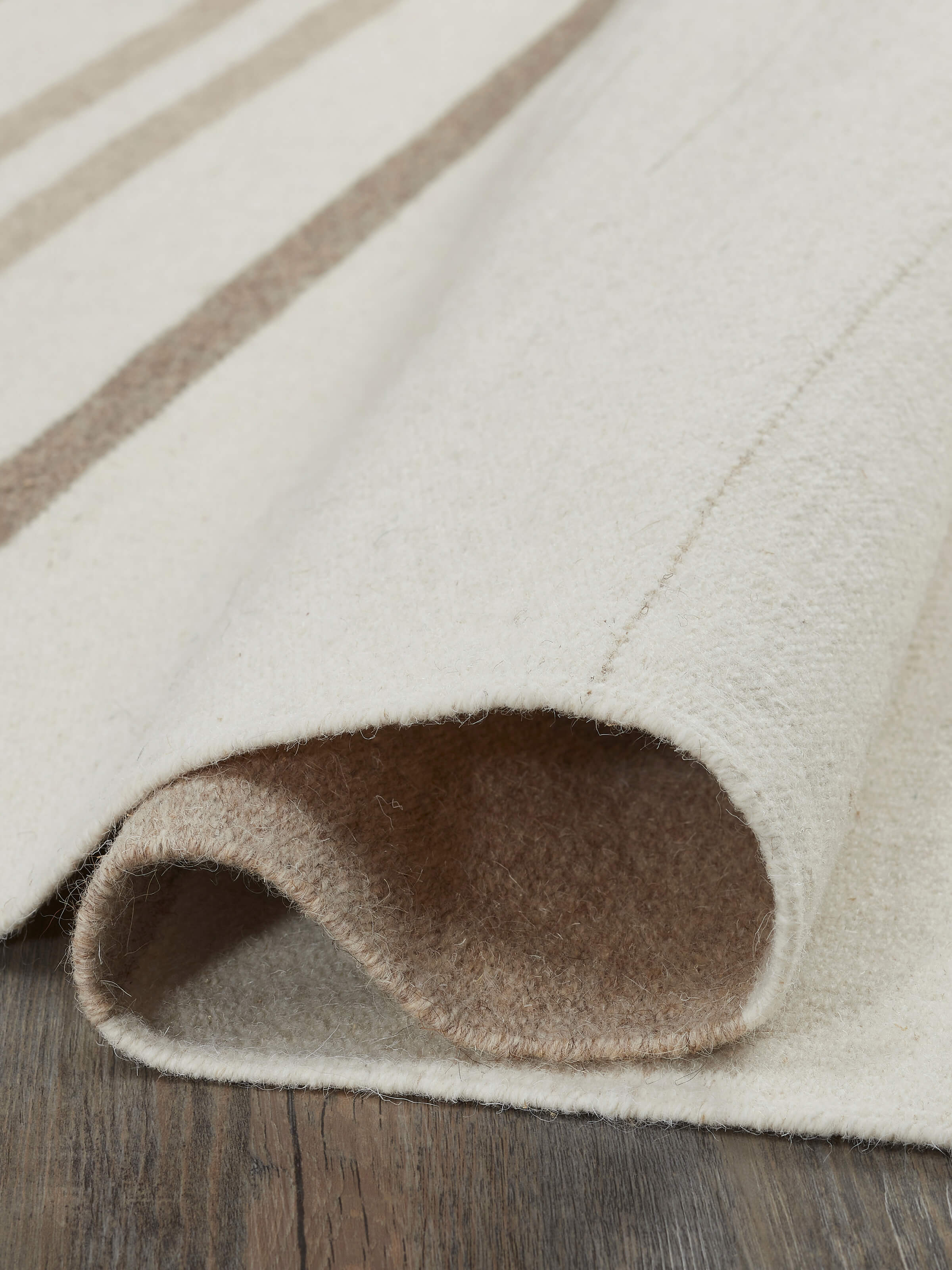 Detailed view of Nomad stripes ivory Jawaja wool & cotton handloom dhurrie, focusing on the pattern and material