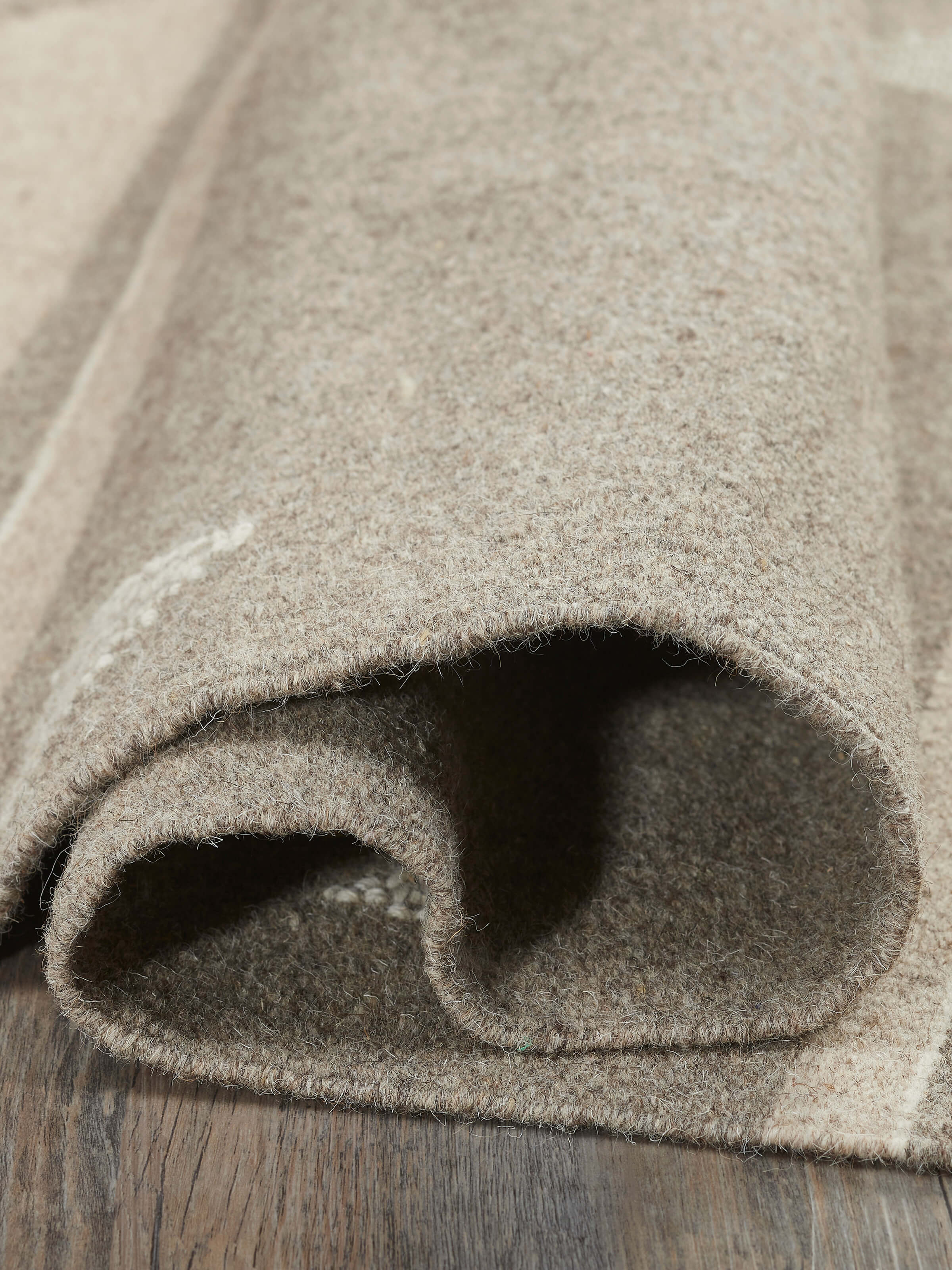 Angled view of Nomad stripes buti beige Jawaja wool & cotton handloom dhurrie (3x5 ft) displaying the full design and artisanal weaving.