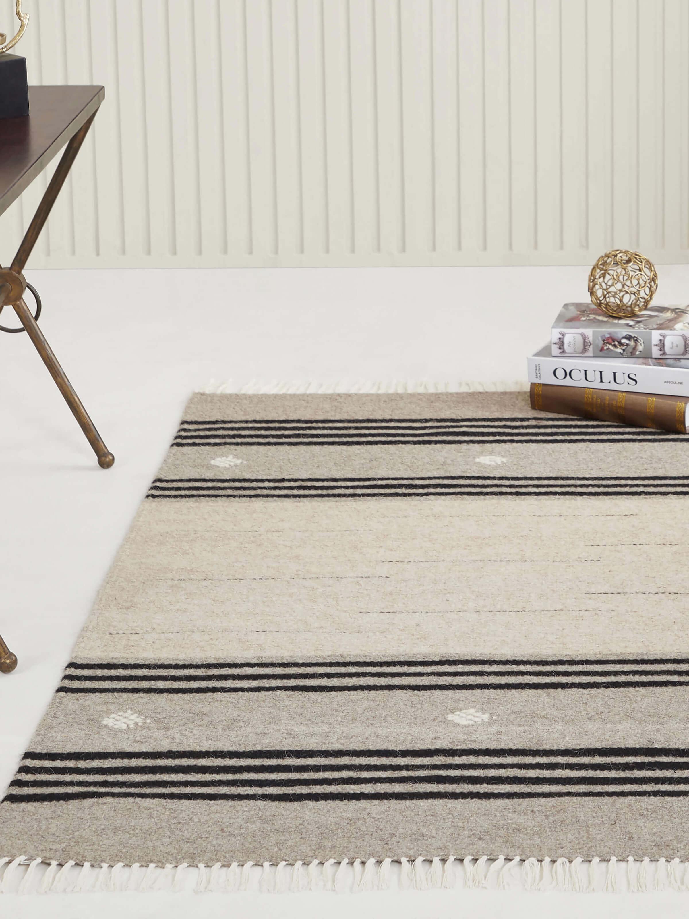 Lifestyle image of beige and black Jawaja wool dhurrie with stripe pattern