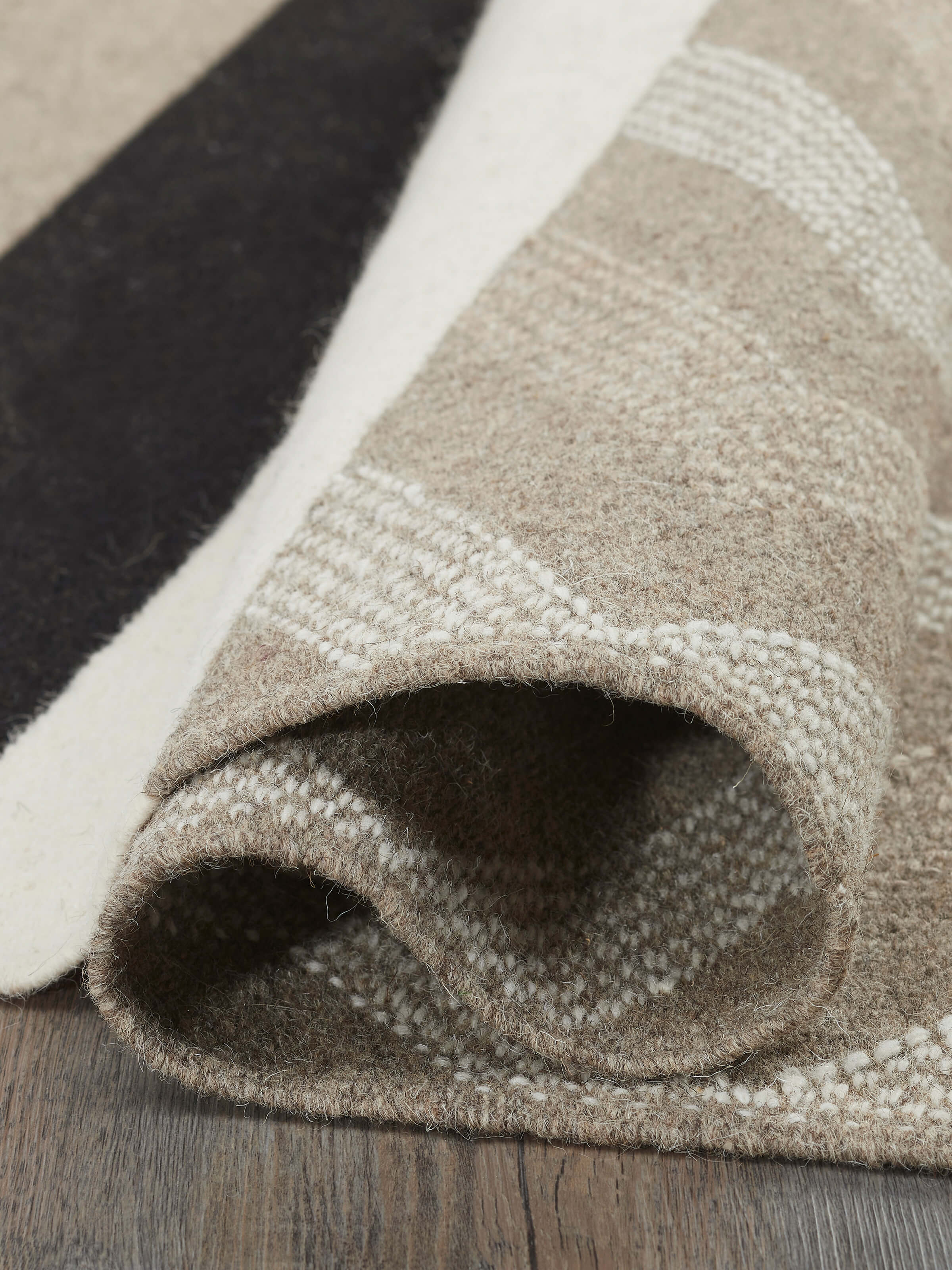 Full-length view of Textured Chevron Grey Melange Jawaja Wool & Cotton Handloom Dhurrie (3x5 ft) on the floor, showcasing its use.