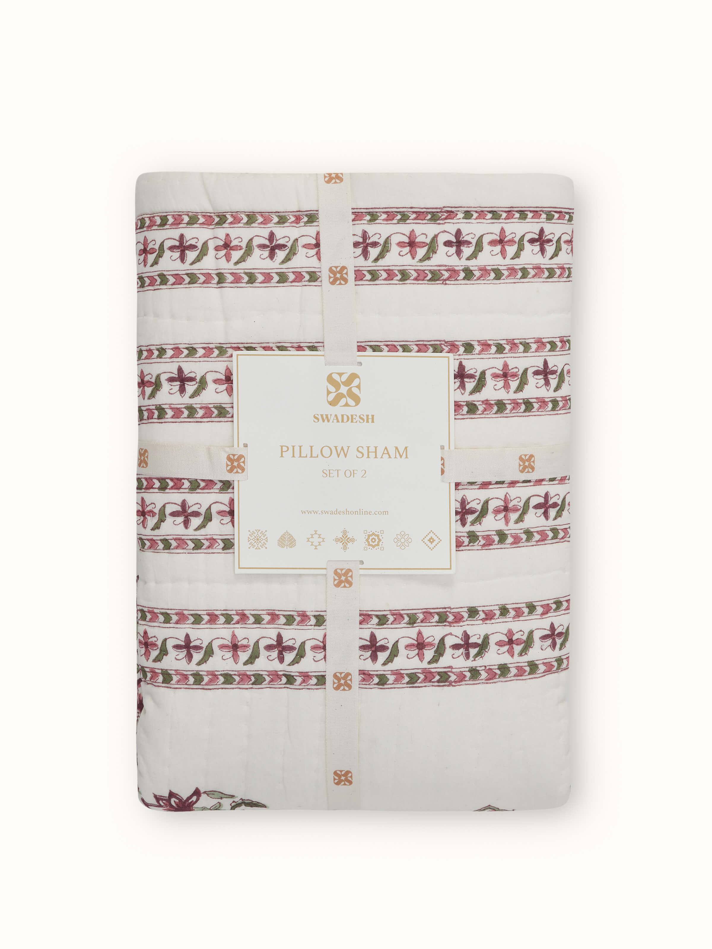 Aarunya red floral cotton pillow shams folded, showing the Sanganeri block print and rich red floral design in detail.