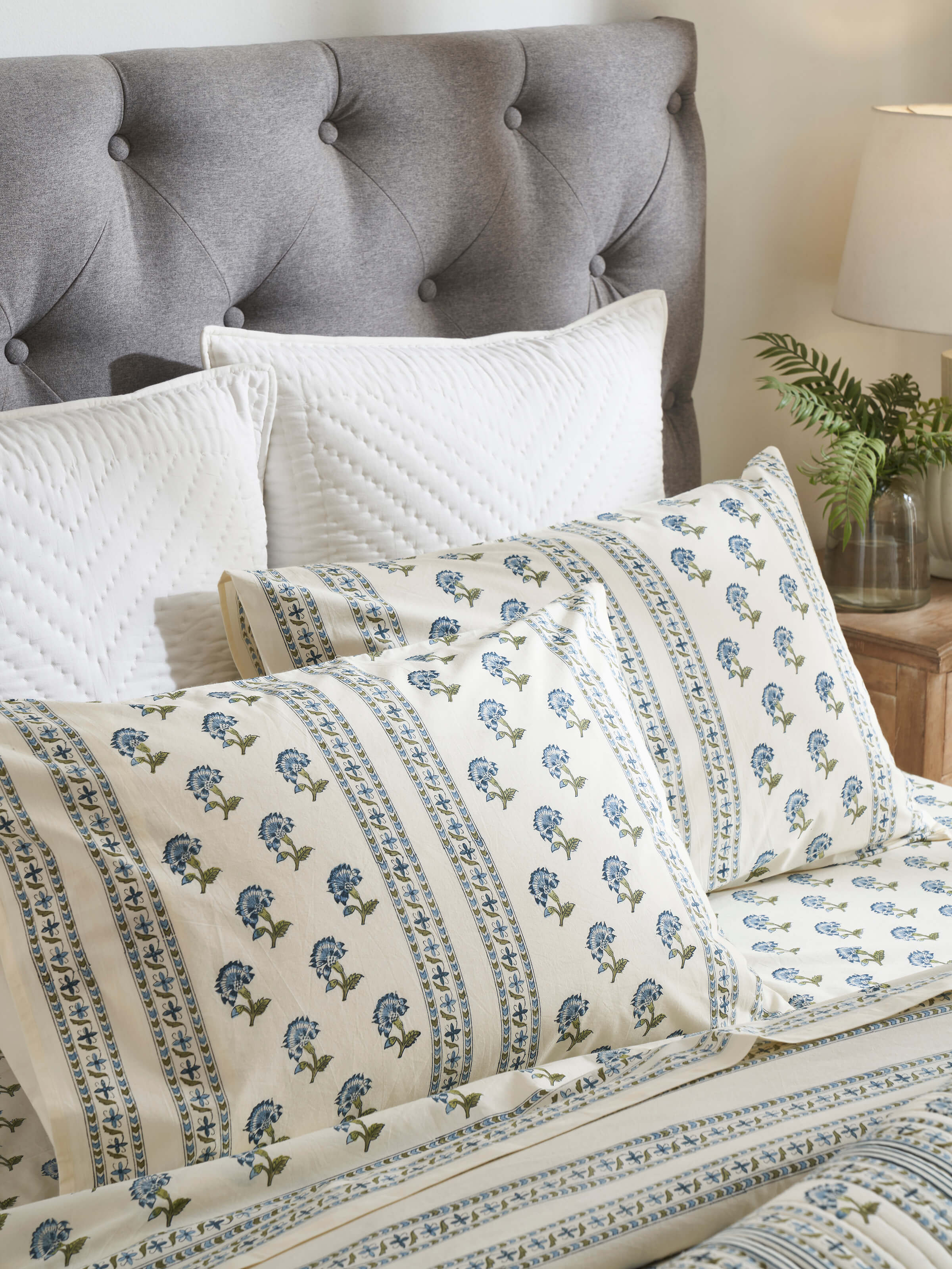 Lifestyle image of Aarunya Blue Buti Cotton Sanganeri Block Printed Pillow Cases (2 pcs) on a bed with a traditional design.