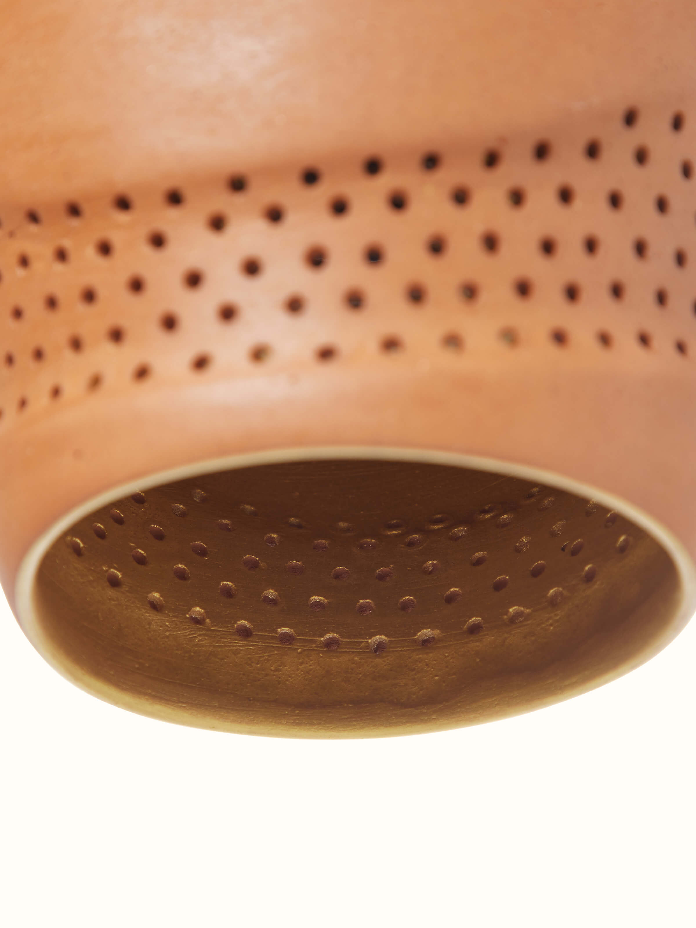 Terracotta pendant lights set in a setting, demonstrating their aesthetic appeal and lighting effect.