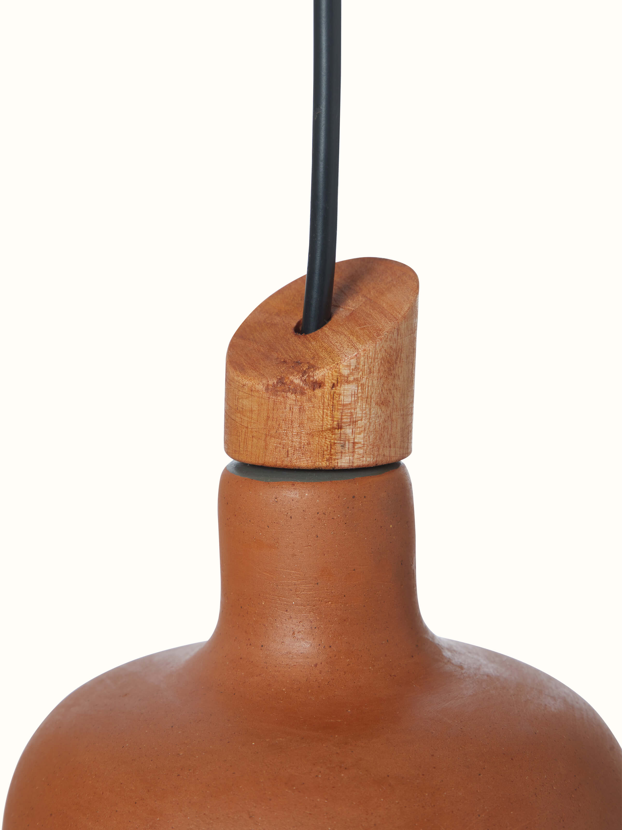 Detailed view of terracotta pendant lights, focusing on the texture and finish of the material.