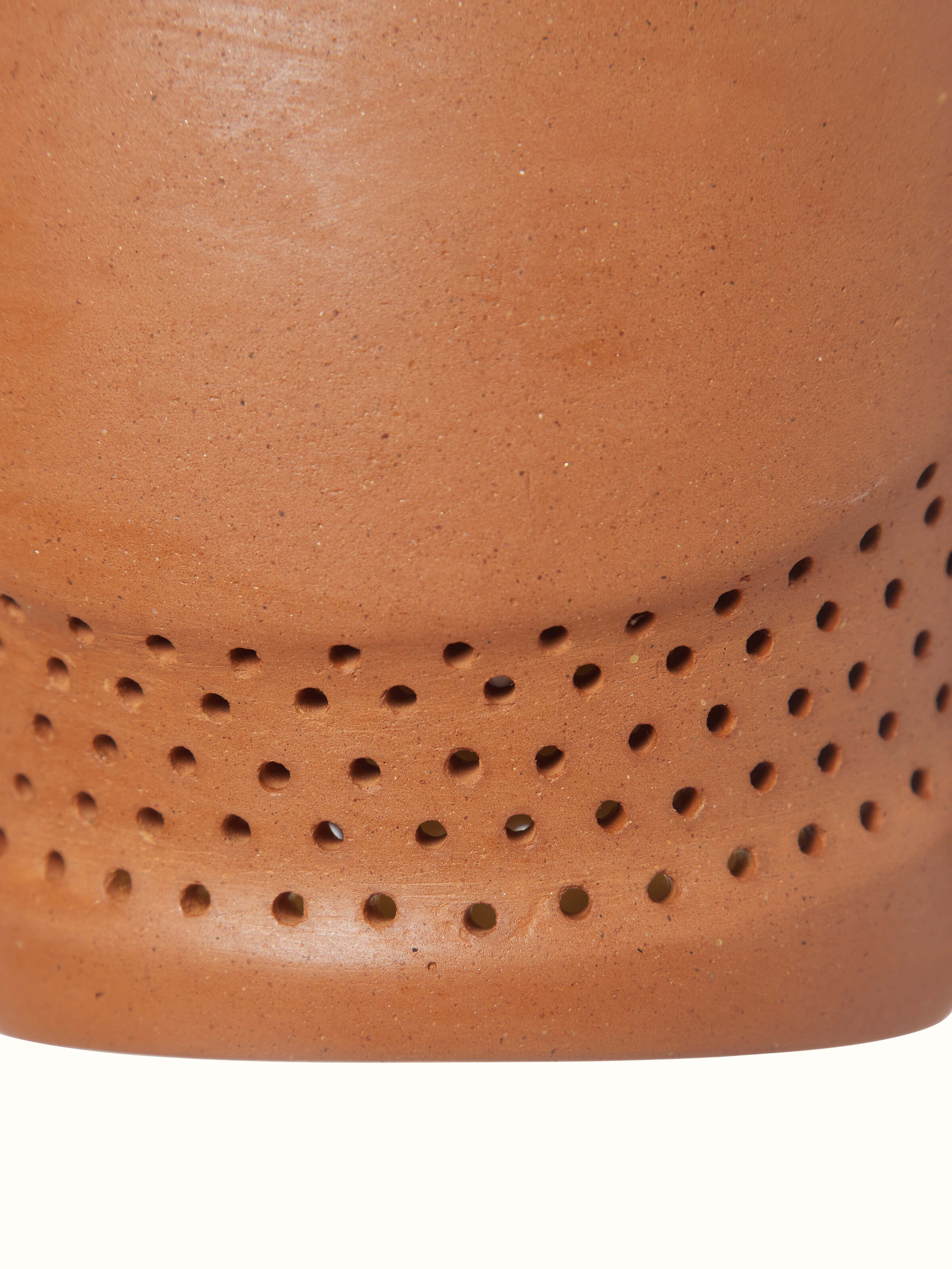 Terracotta pendant lights set against a neutral background, illustrating their versatility and design.