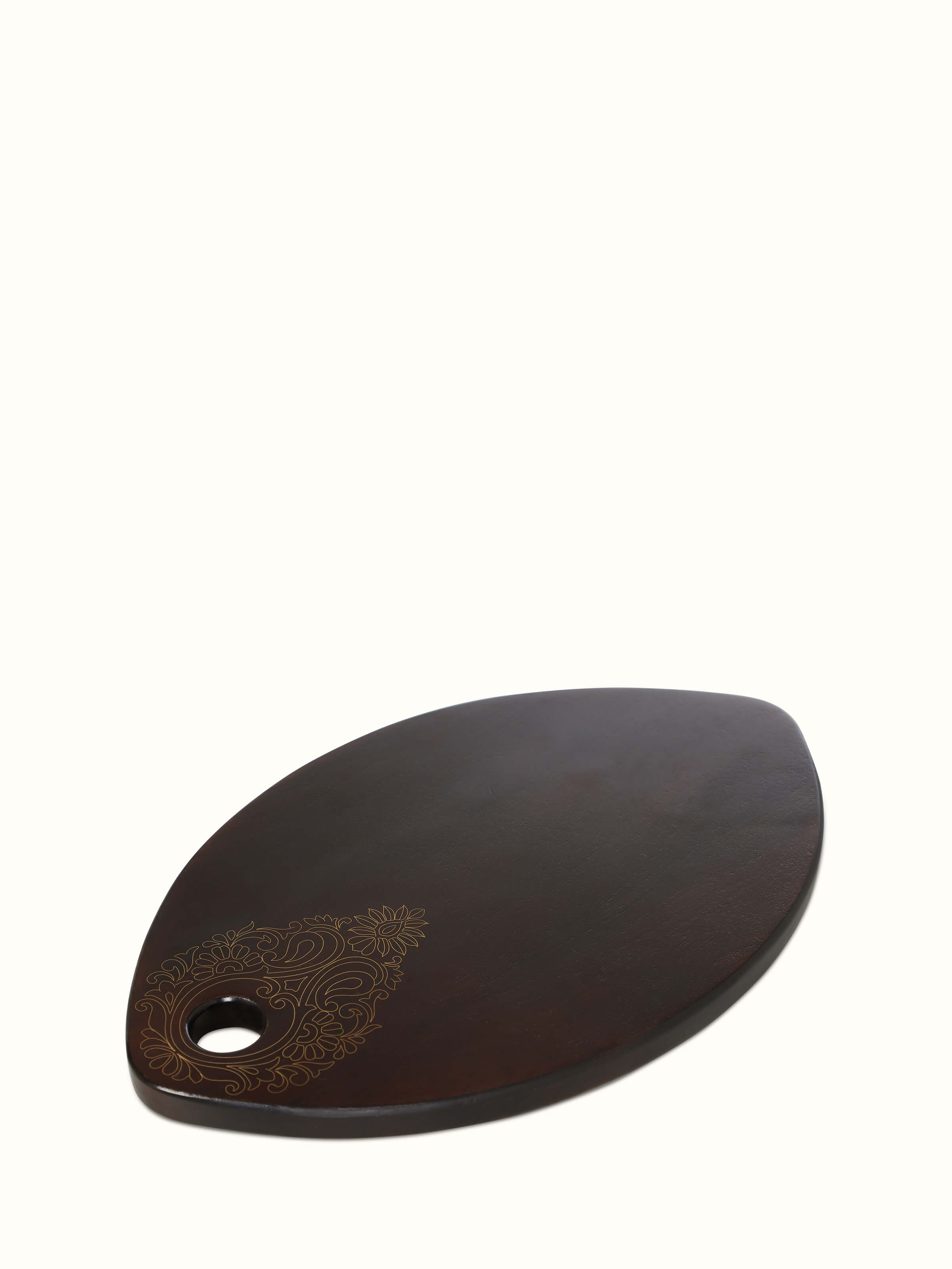 Close-up of Tarkashi sheesham wood & brass chopping board focusing on its intricate design