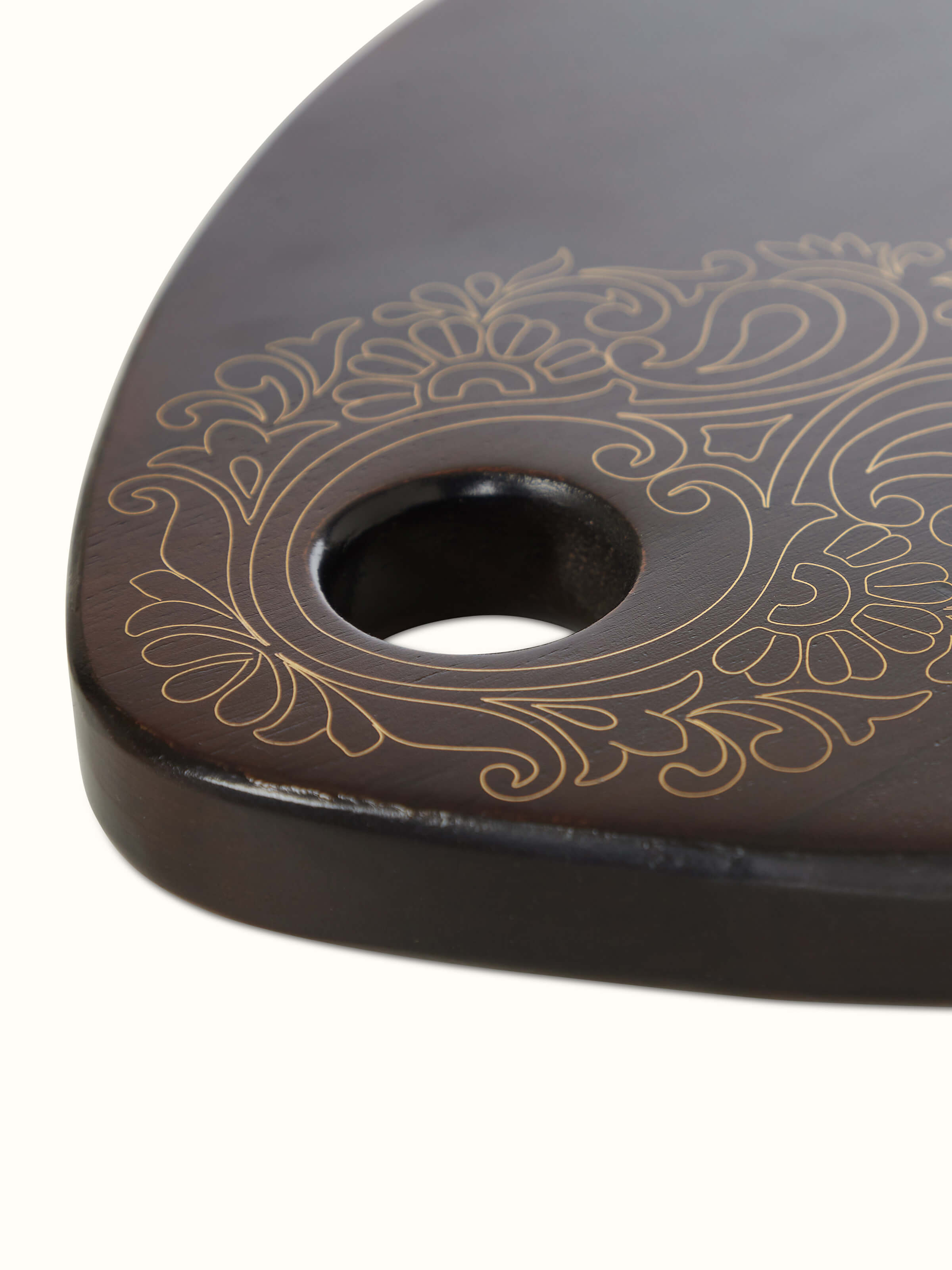 Detailed view of Tarkashi sheesham wood & brass chopping board highlighting its high-quality finish