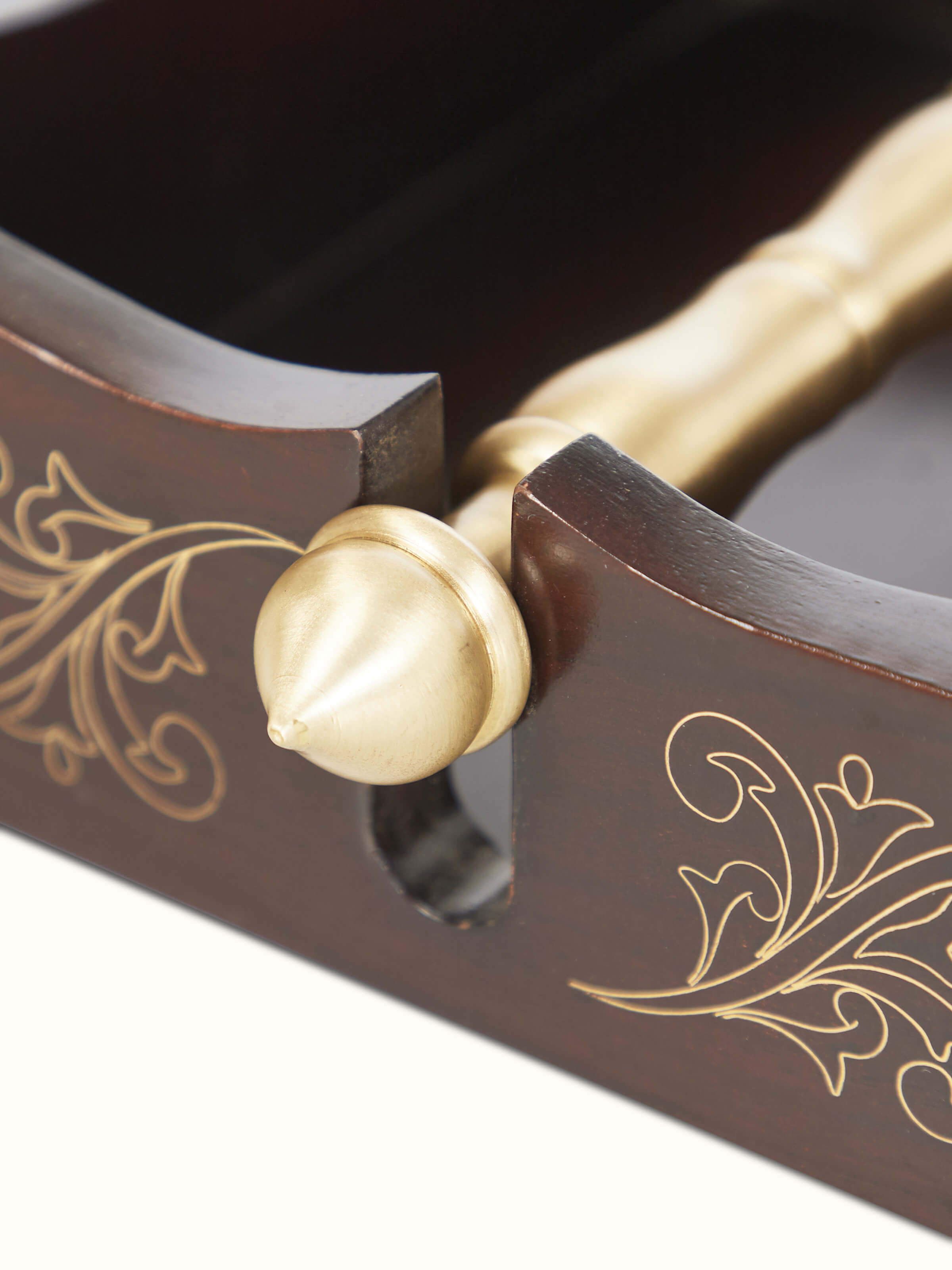 Angled view of Tarkashi Sheesham wood & brass napkin holder showcasing its unique shape and detailed workmanship