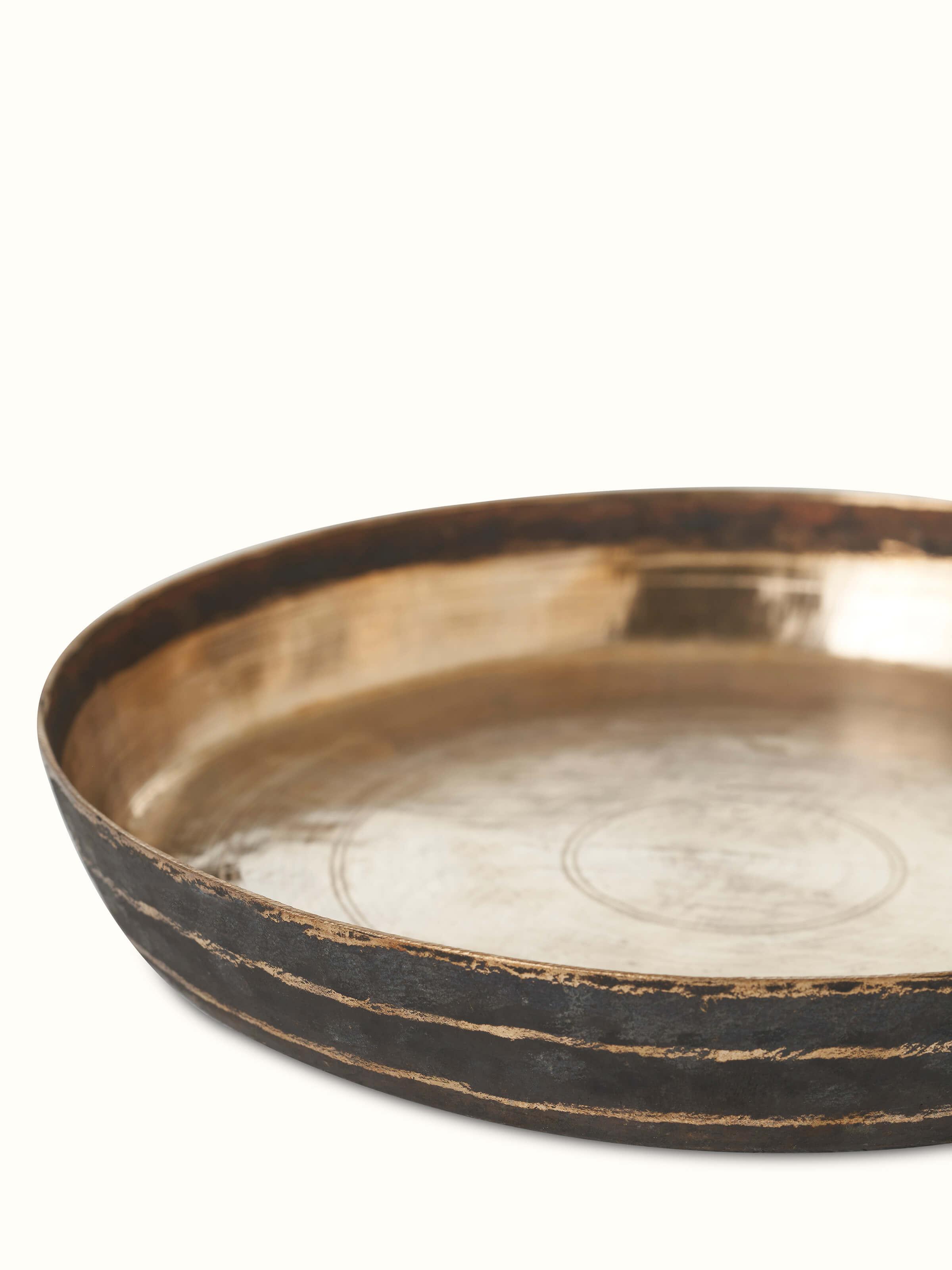 Angled view of Bell Metal Dinner Plate (11 inches) showcasing its refined metalwork and craftsmanship.