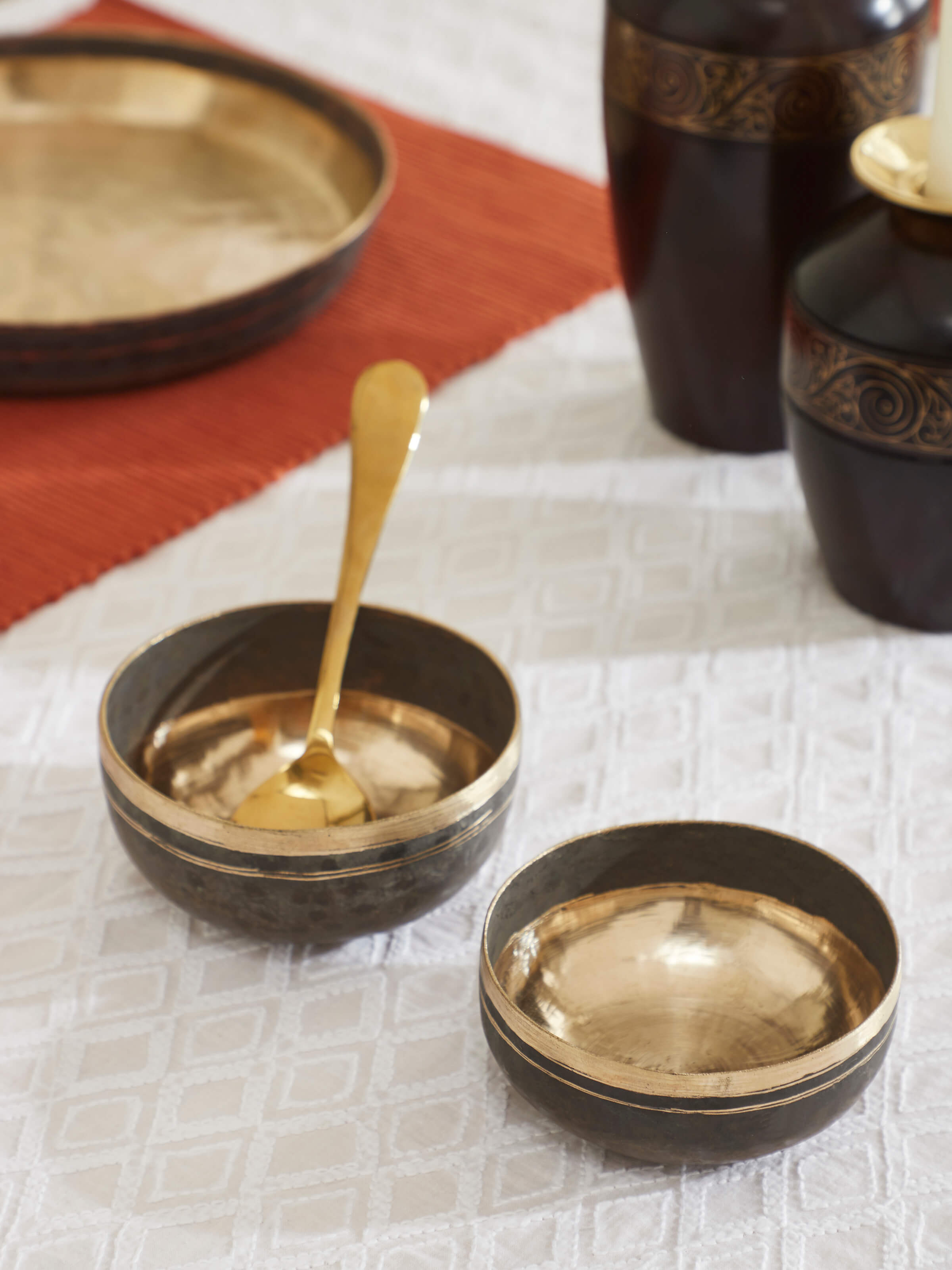 Side view of Bell metal dinner bowls highlighting the curved design and detail.