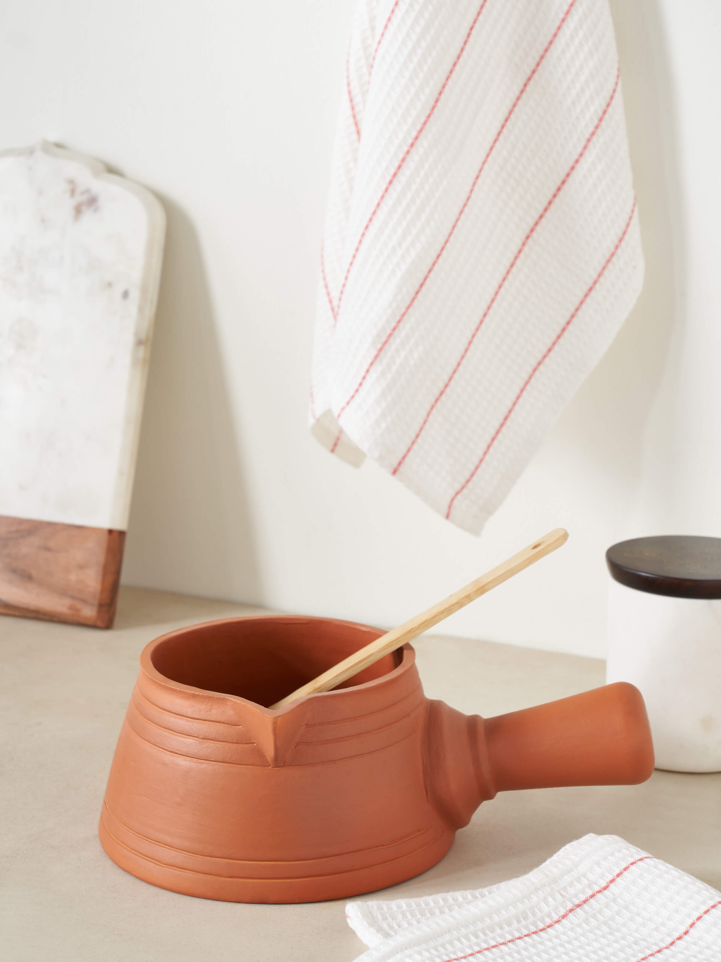 Side view of Natural Terracotta Clay saucepan highlighting its practical design and natural clay texture