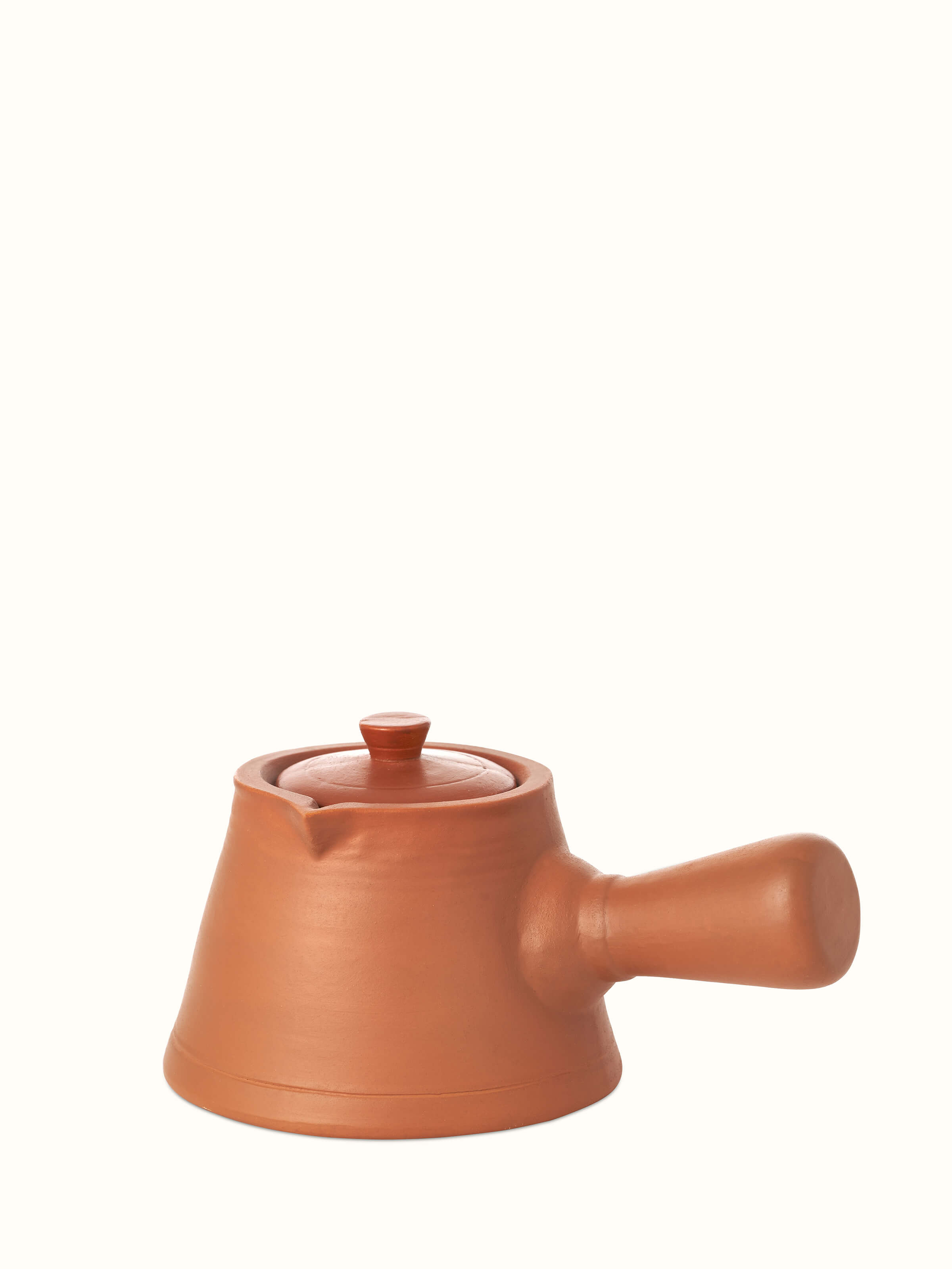 Detailed view of terracotta clay saucepan, showcasing its rustic design and natural finish.
