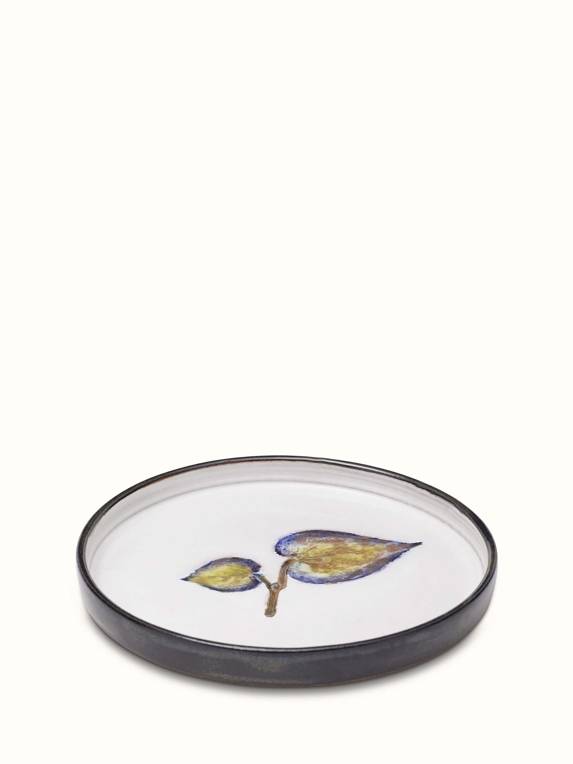Side view of studio pottery ceramic dessert plate with smooth, glossy finish