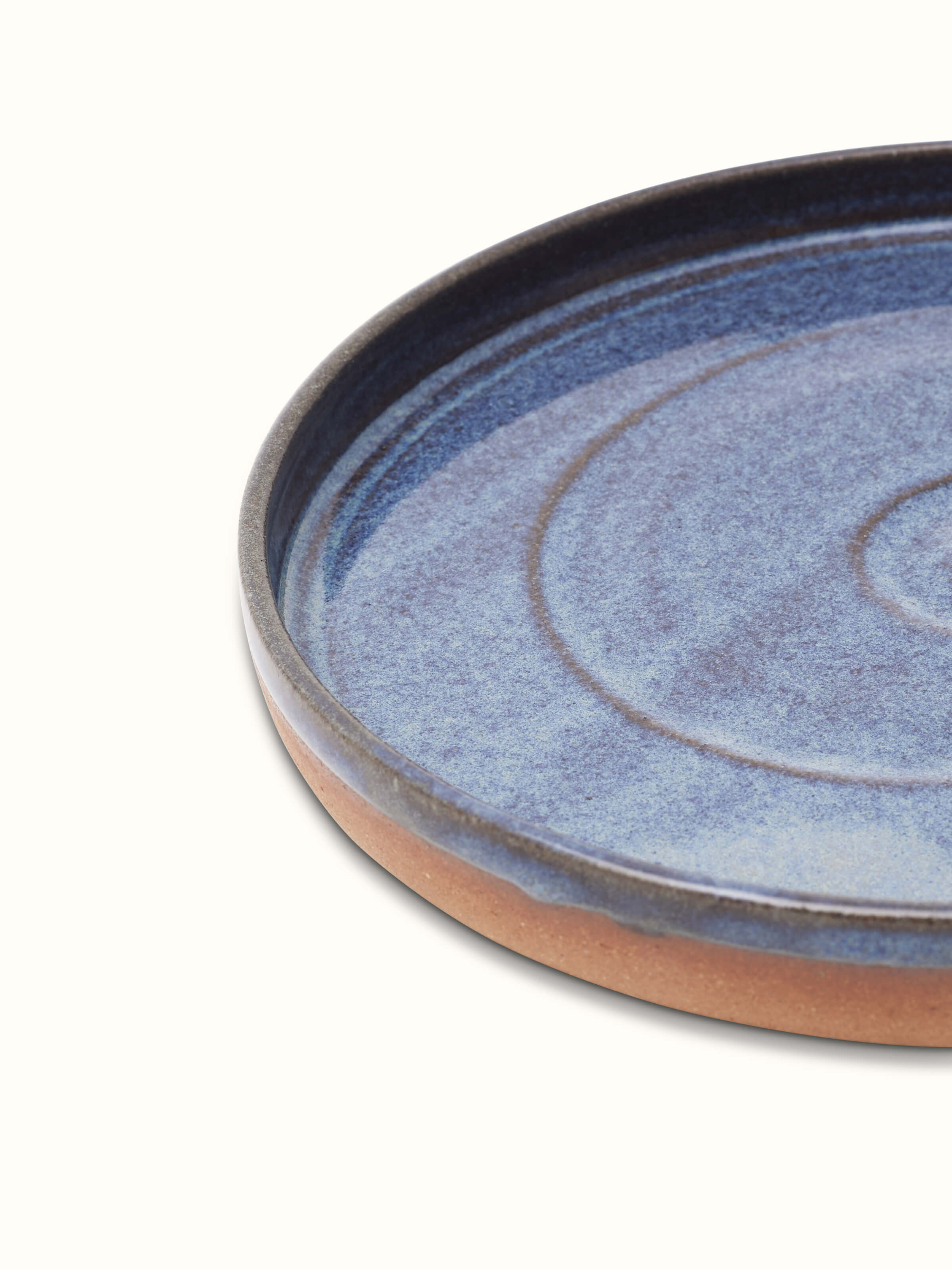 Detailed view of studio pottery ceramic blue dessert plate showcasing the artisanal quality and unique blue tone