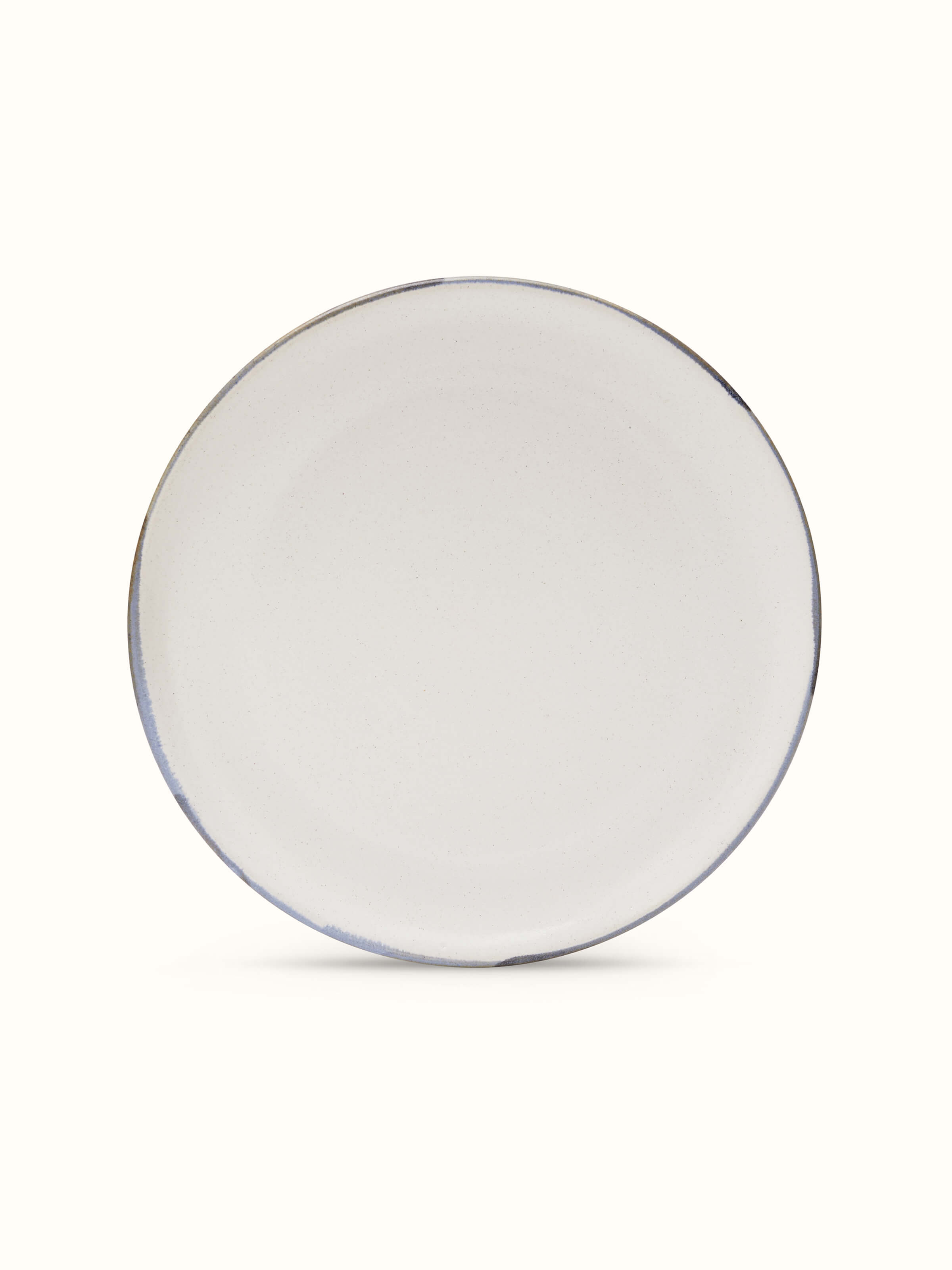 Front view of studio pottery ceramic white dinner plate featuring a minimalist design and smooth finish