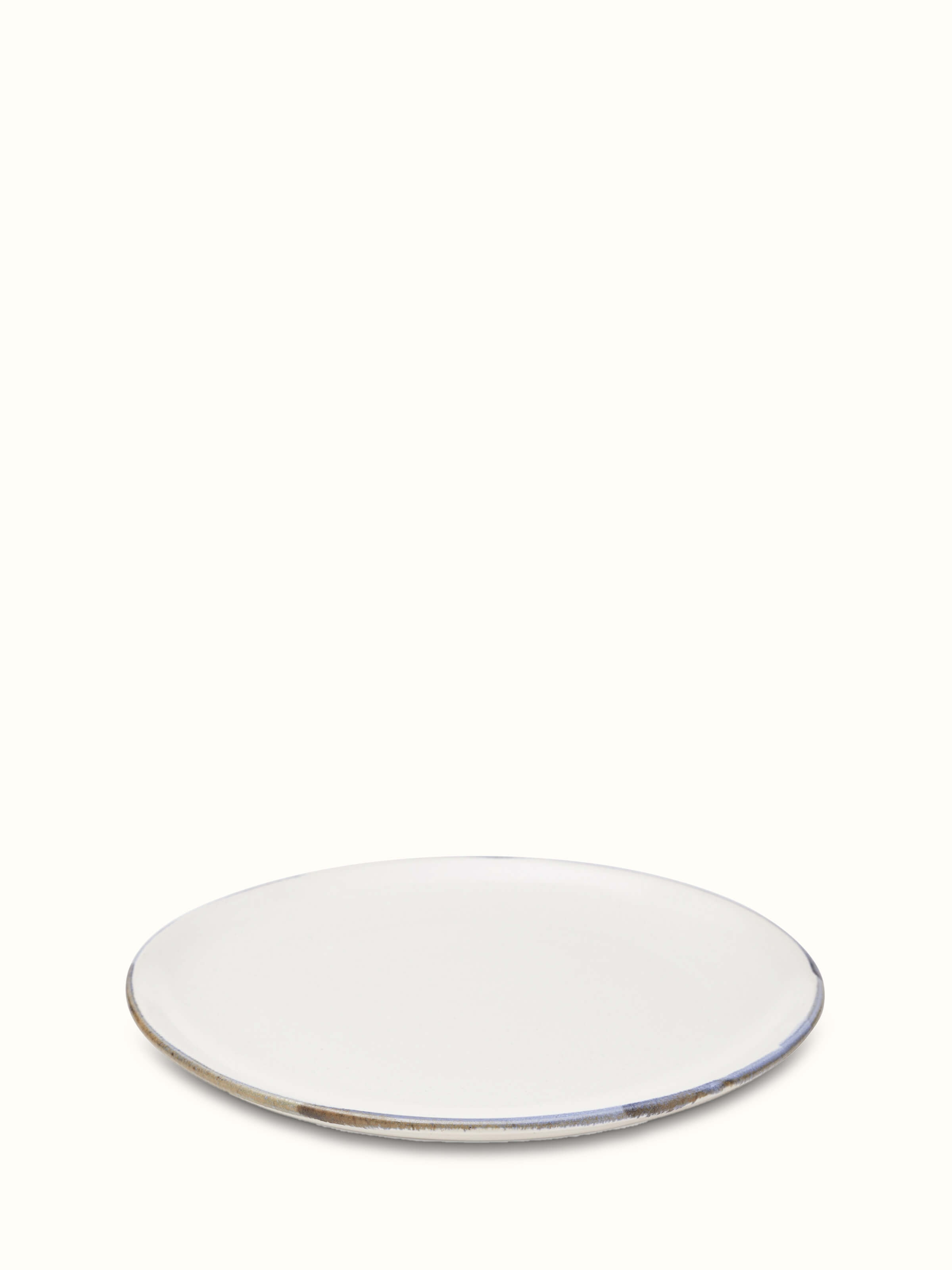 Top-down view of studio pottery ceramic white dinner plate highlighting its classic round shape and pristine surface