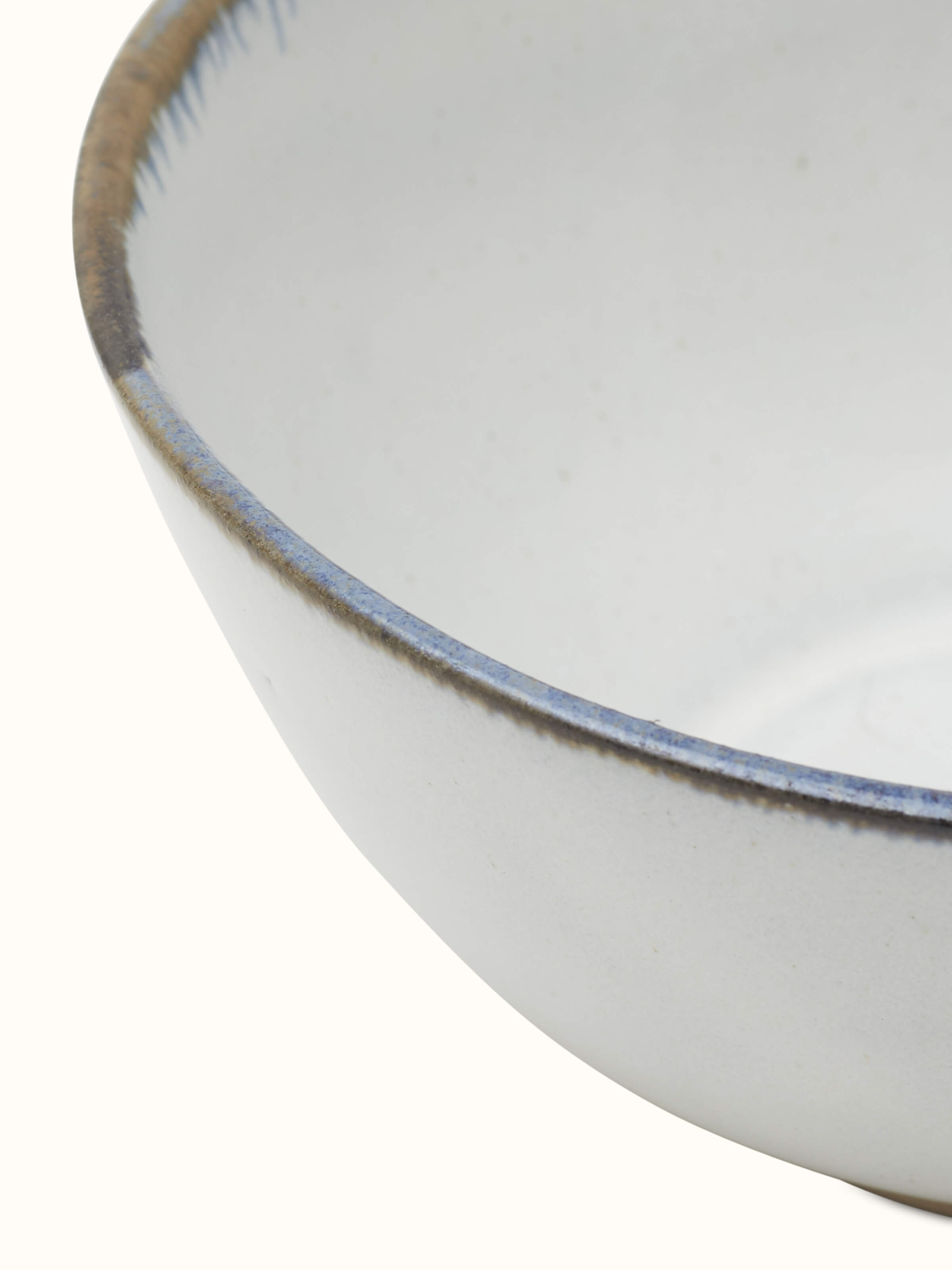 Side view of glazed studio pottery ceramic serving bowl highlighting its texture