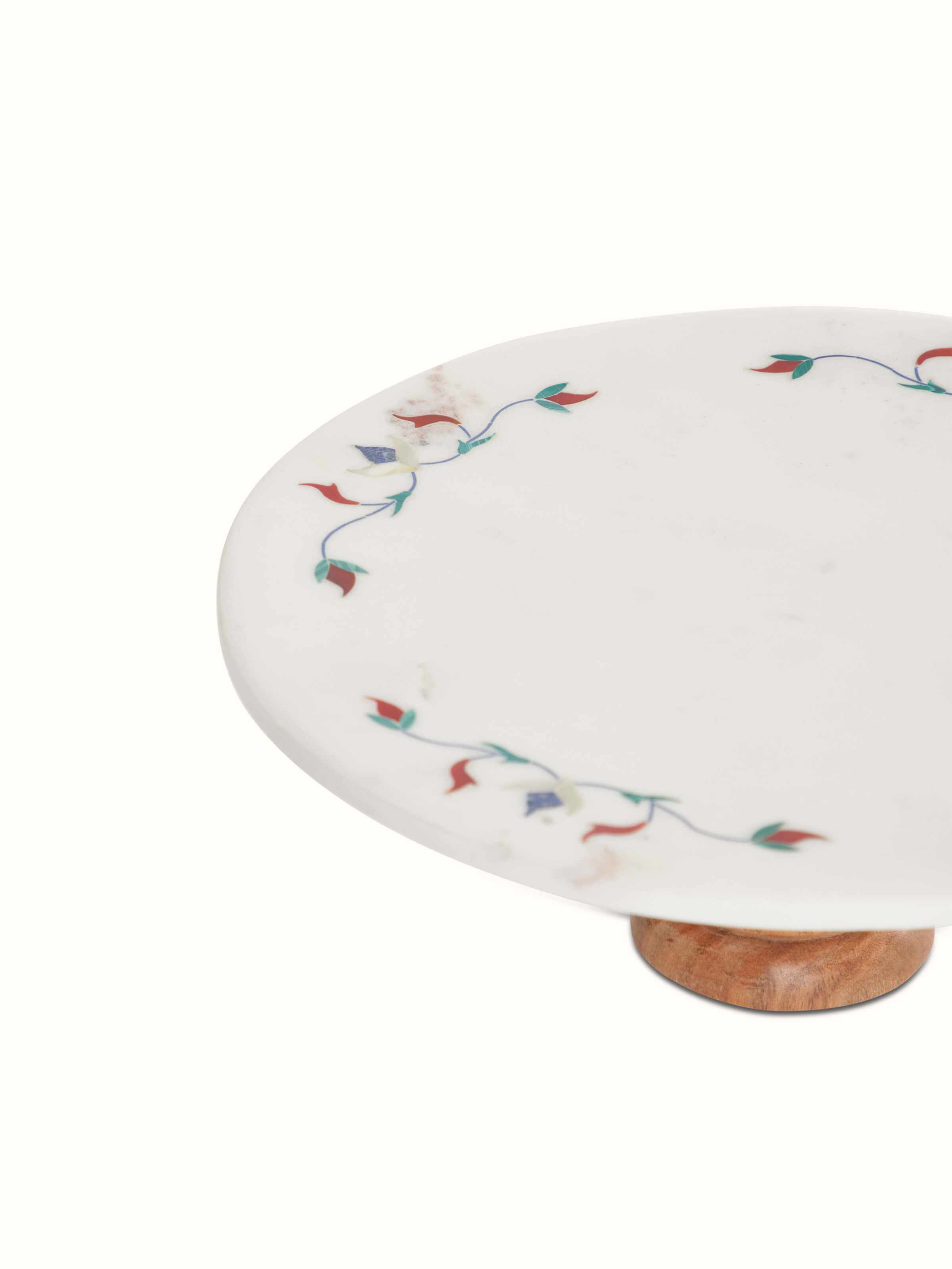 Top view of marble inlaid circular cake stand, emphasizing the detailed floral inlay and elegant presentation.