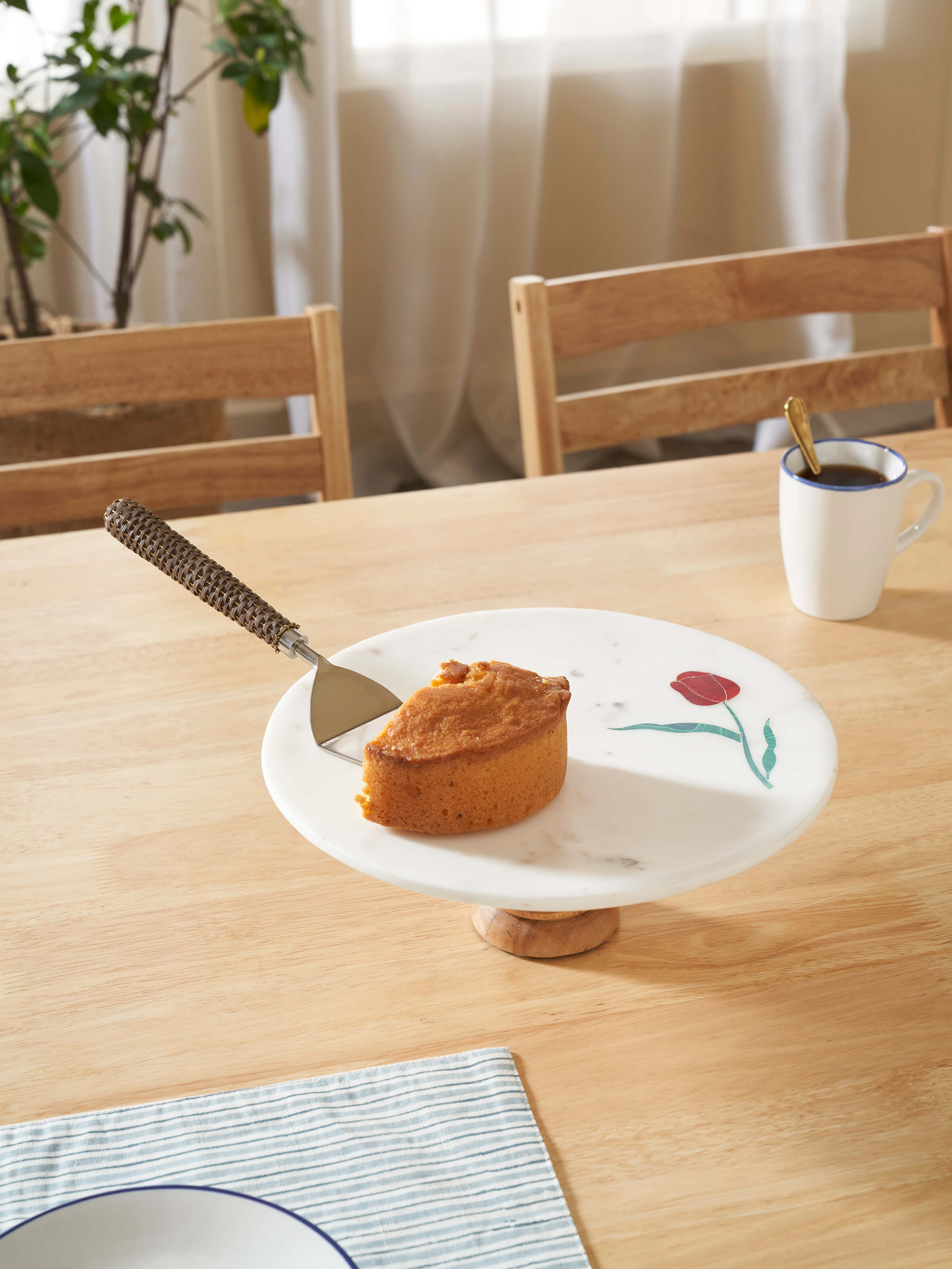 Side view of marble inlaid cake stand highlighting the pedestal base and ornate inlay design.